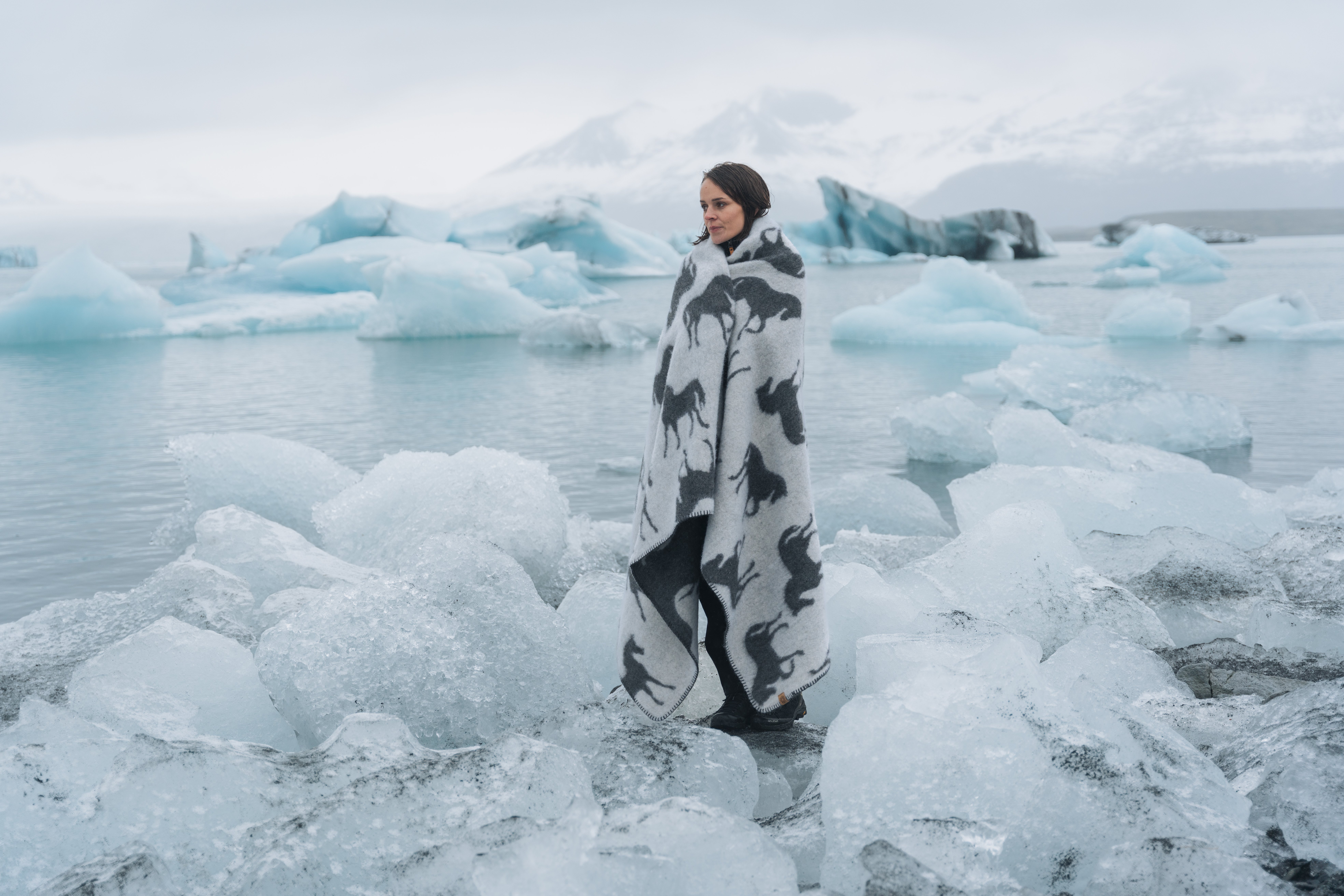 woman standing by the glacial lake