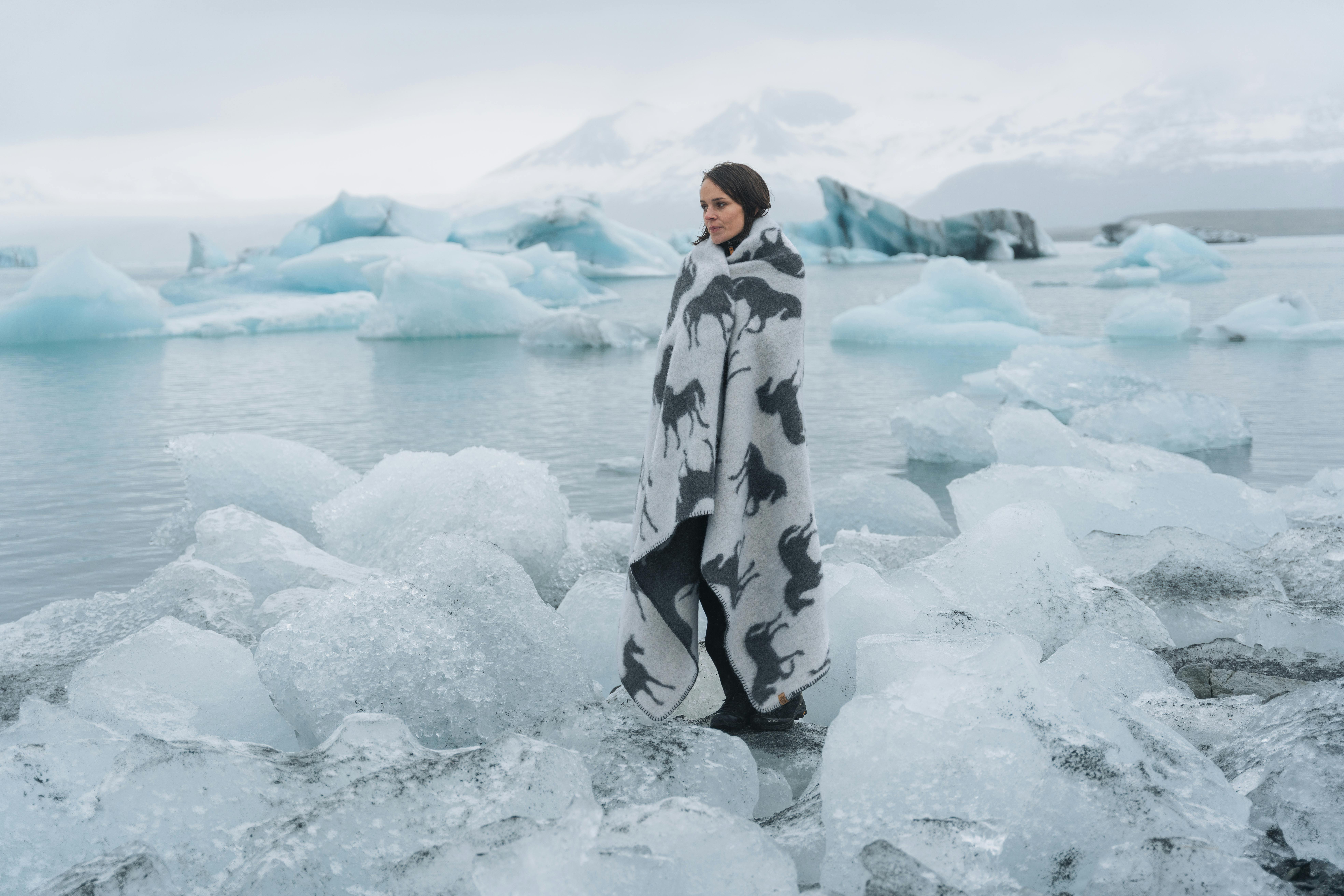 woman standing by the glacial lake