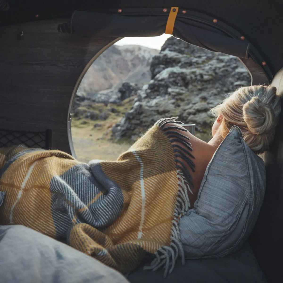 girl in tent with a blanket