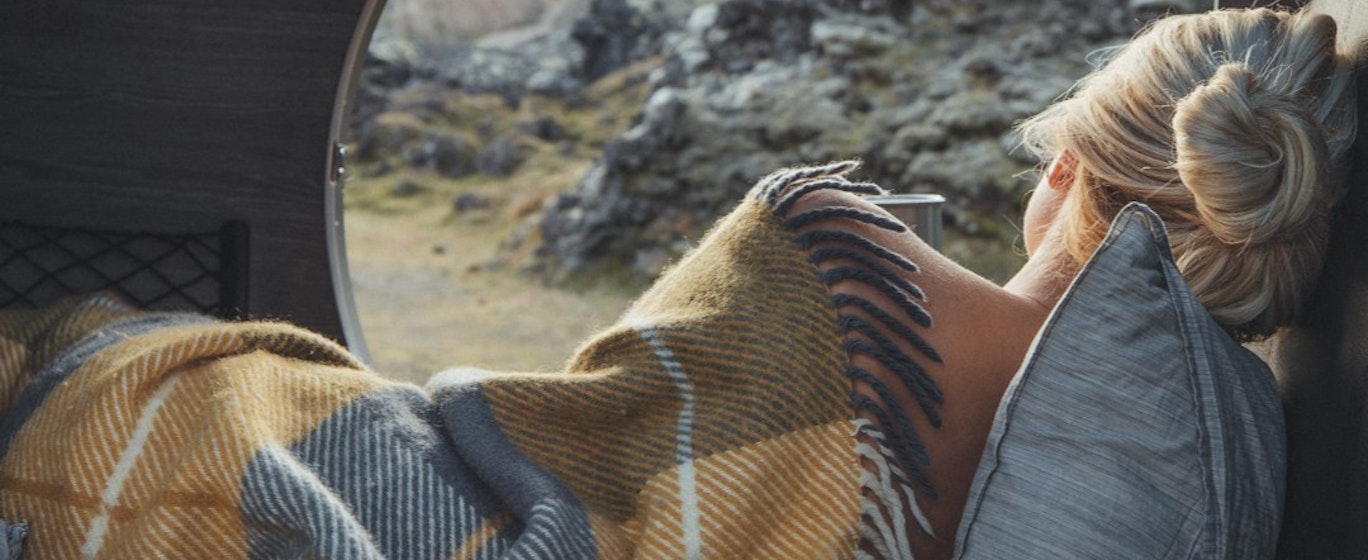 girl in tent with a blanket