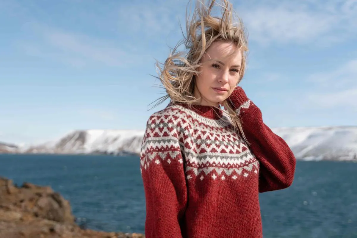woman in Icelandic wool sweater and the sea behind her