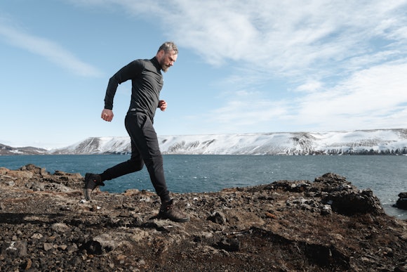 man running by the Icelandic sea