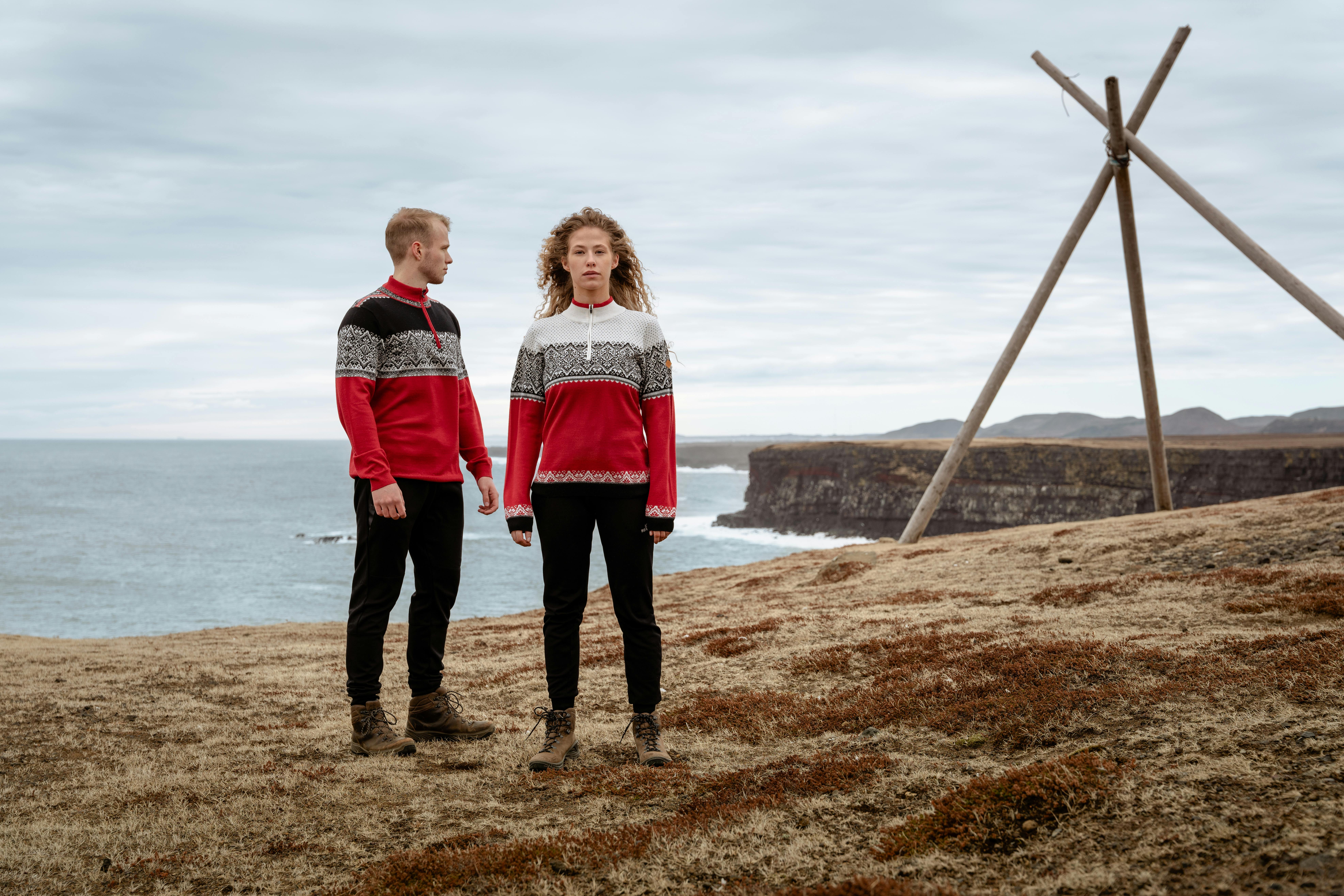 couple wearing Norwegian sweater by the sea