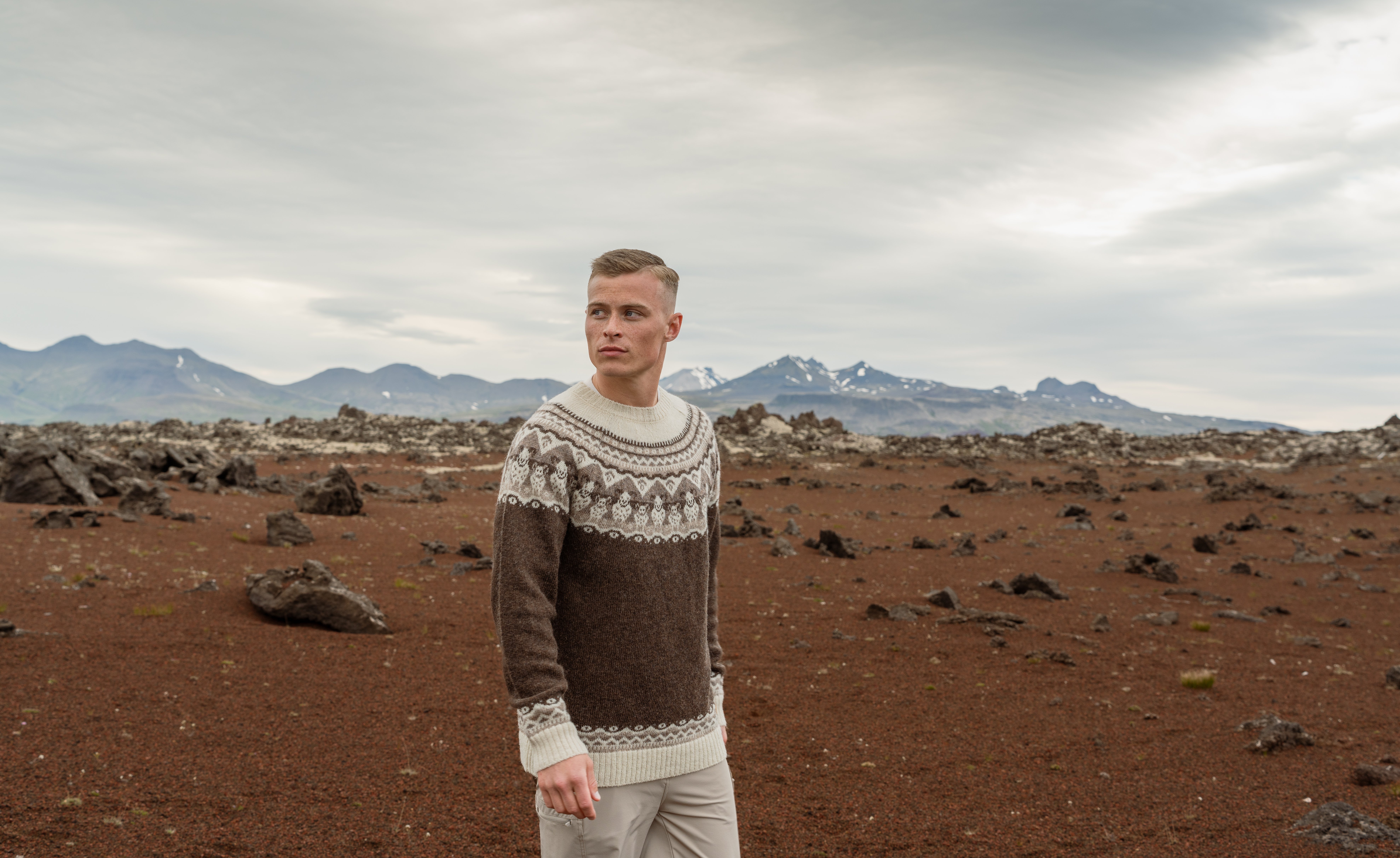 man standing by Icelandic red hills