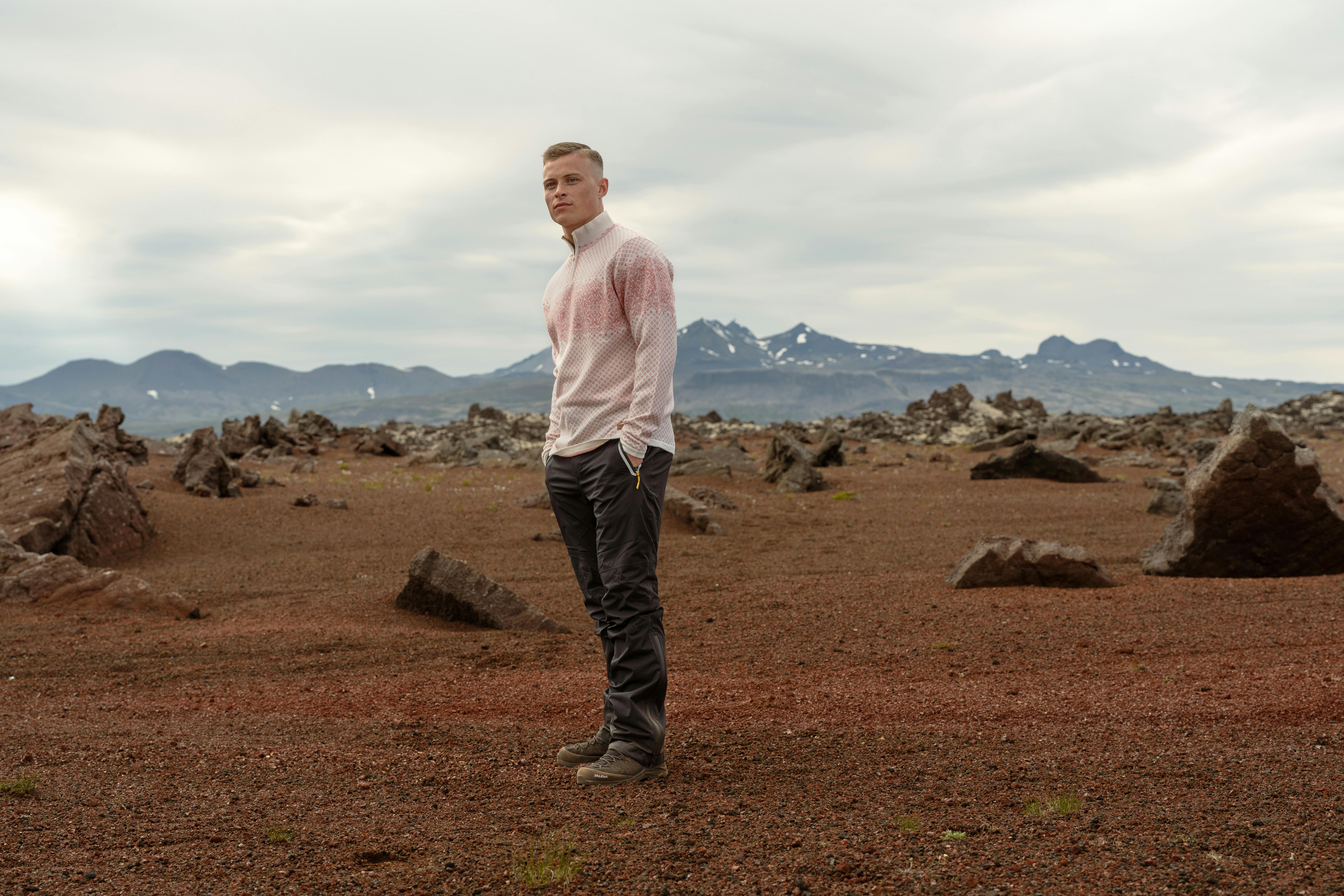 man wearing merino wool sweater in rocky nature