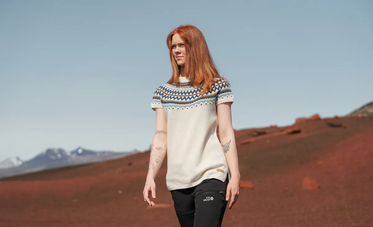 woman wearing sweater vest in a warm summer day in Icelandi