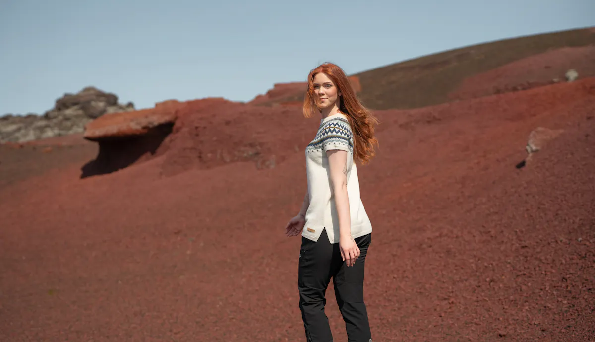 woman walking in red sand in Snæfellsnes, in west Iceland