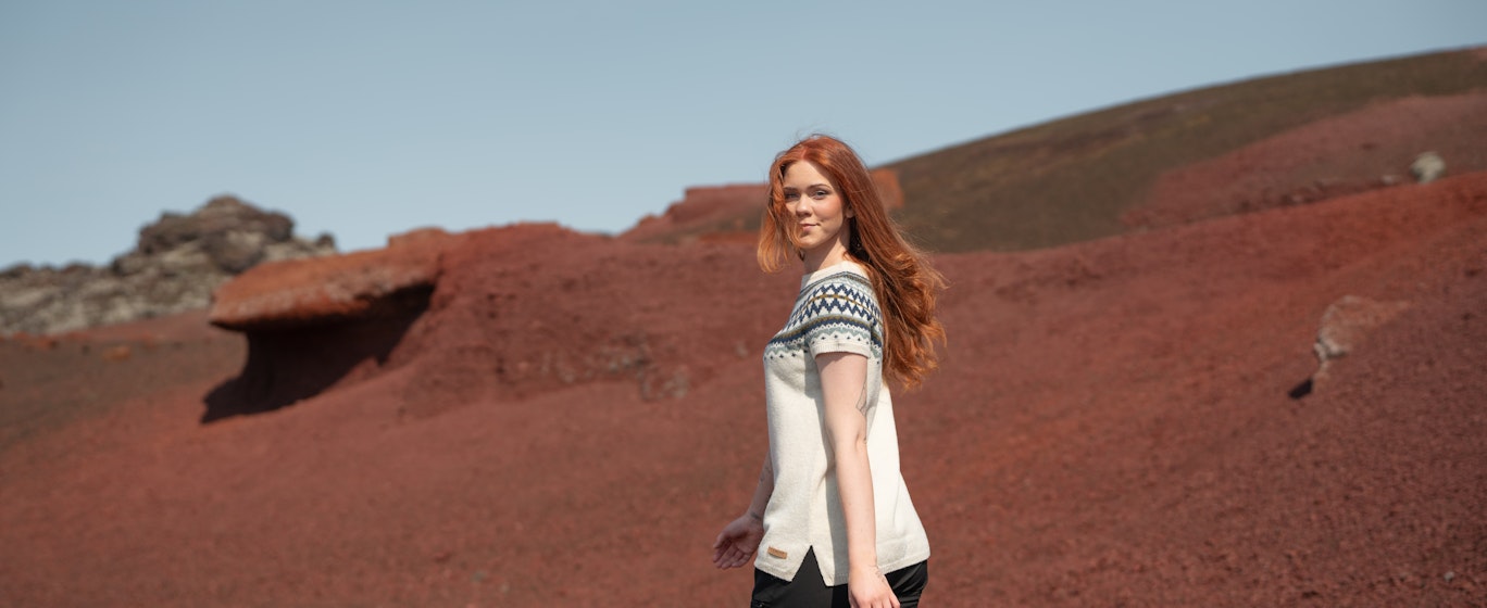 woman walking in red sand in Snæfellsnes, in west Iceland