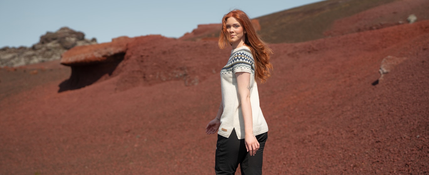 woman walking in red sand in Snæfellsnes, in west Iceland