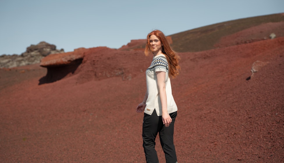 woman walking in red sand in Snæfellsnes, in west Iceland