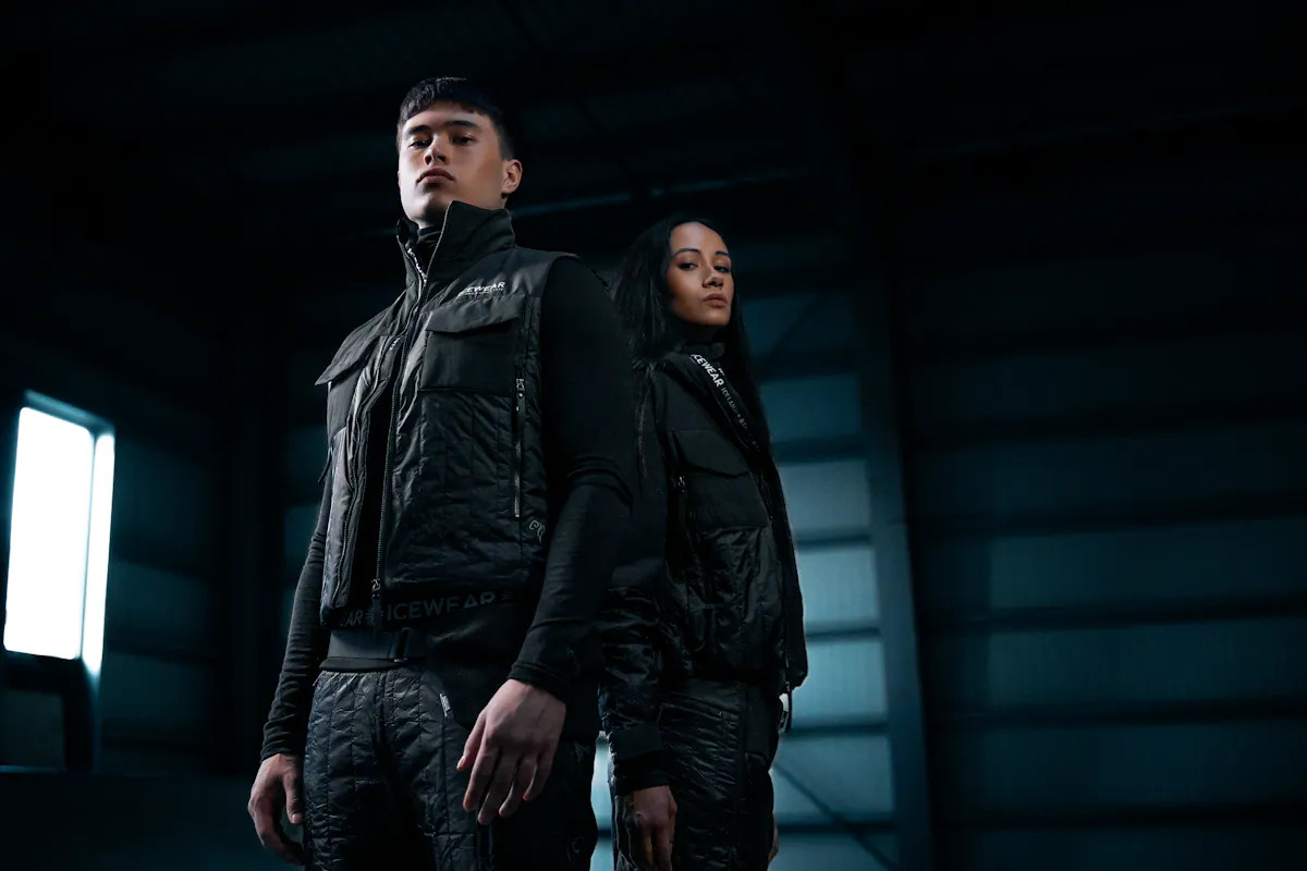 couple in dark warehouse, wearing new Icewear black sheep outfit