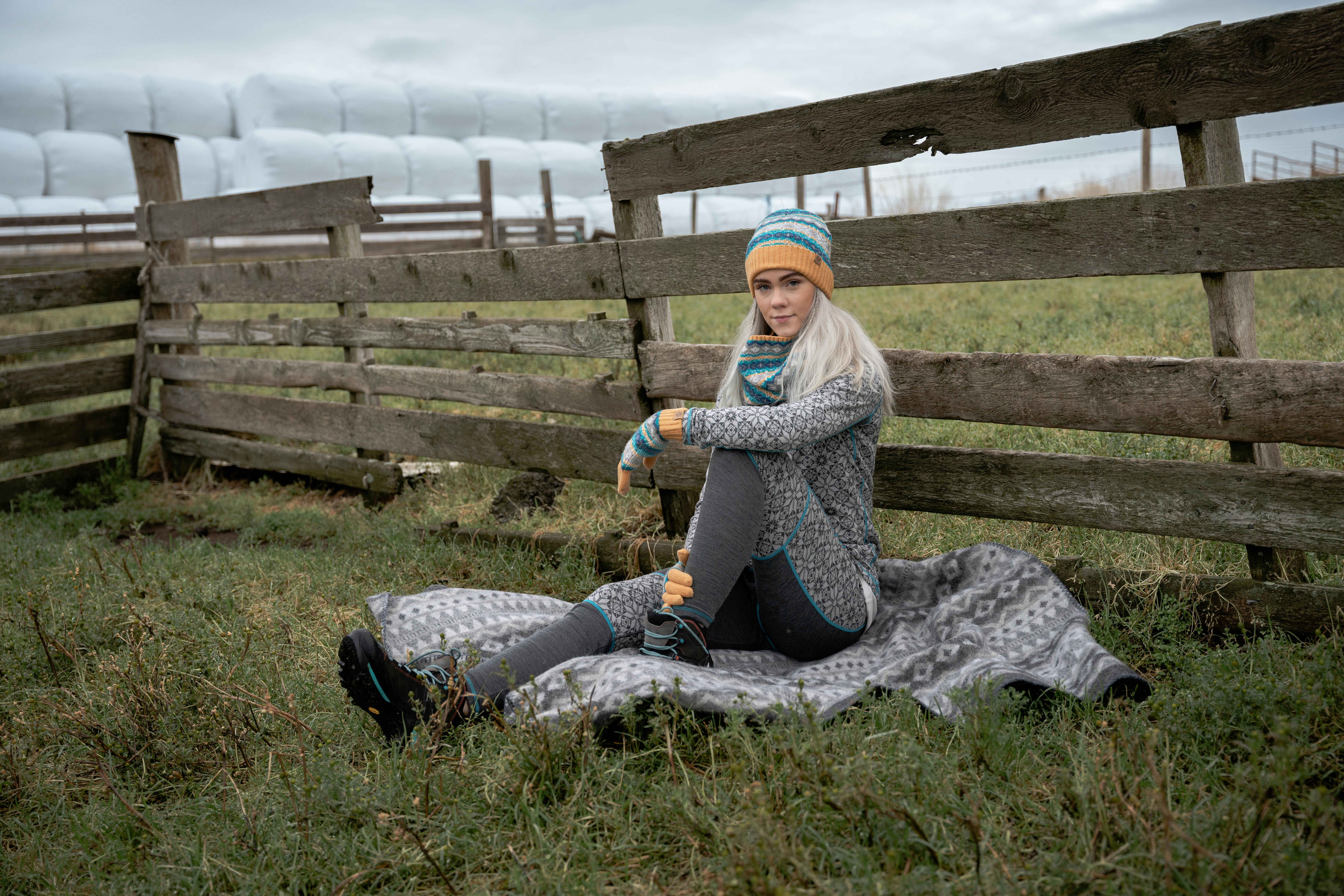 woman sitting on a blanket in the country