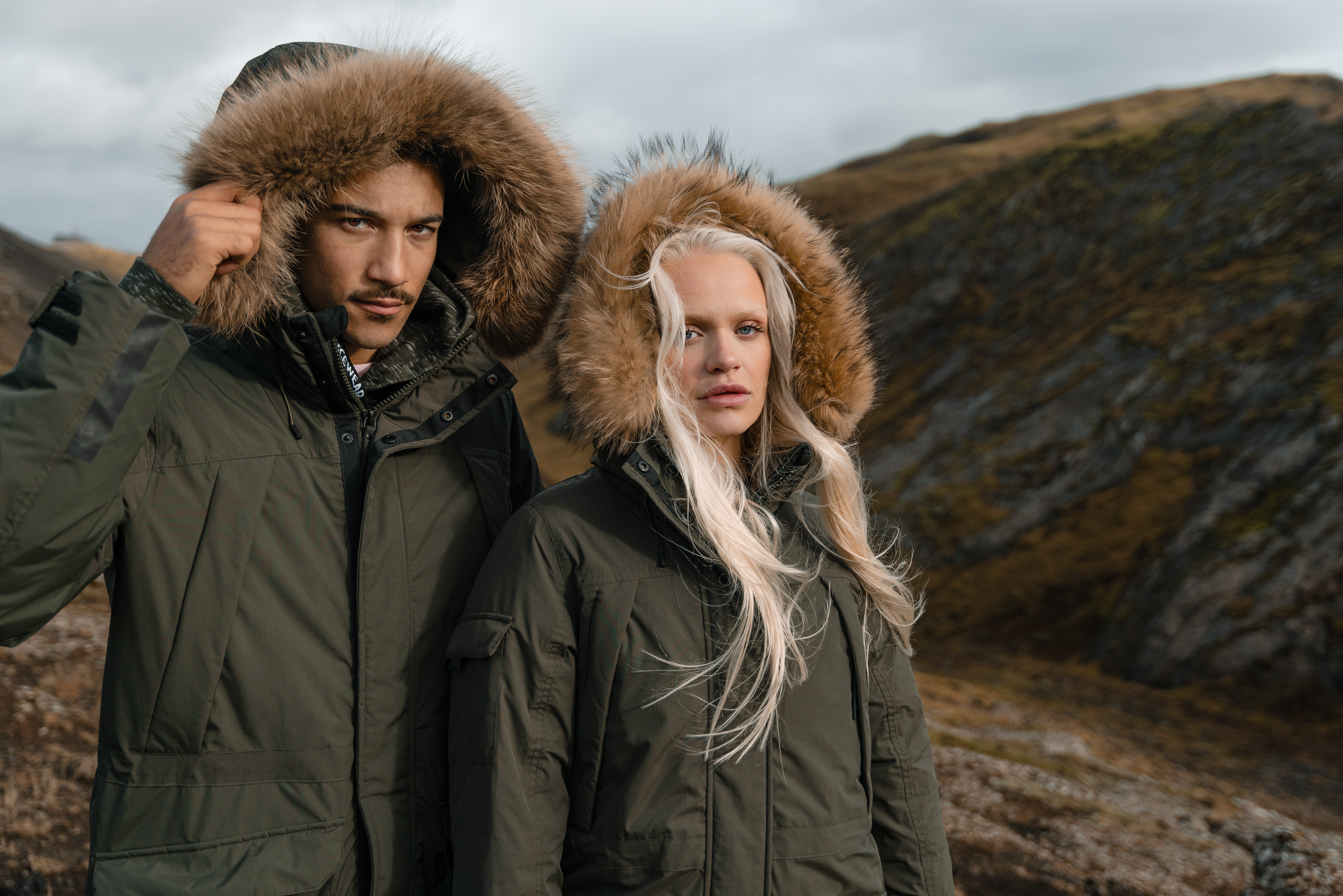 couple in warm parka jacket in the mountain