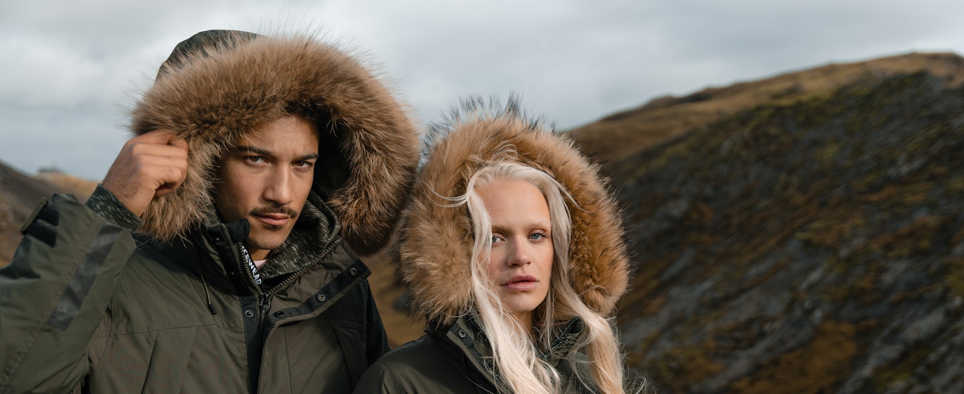 couple in warm parka jacket in the mountain