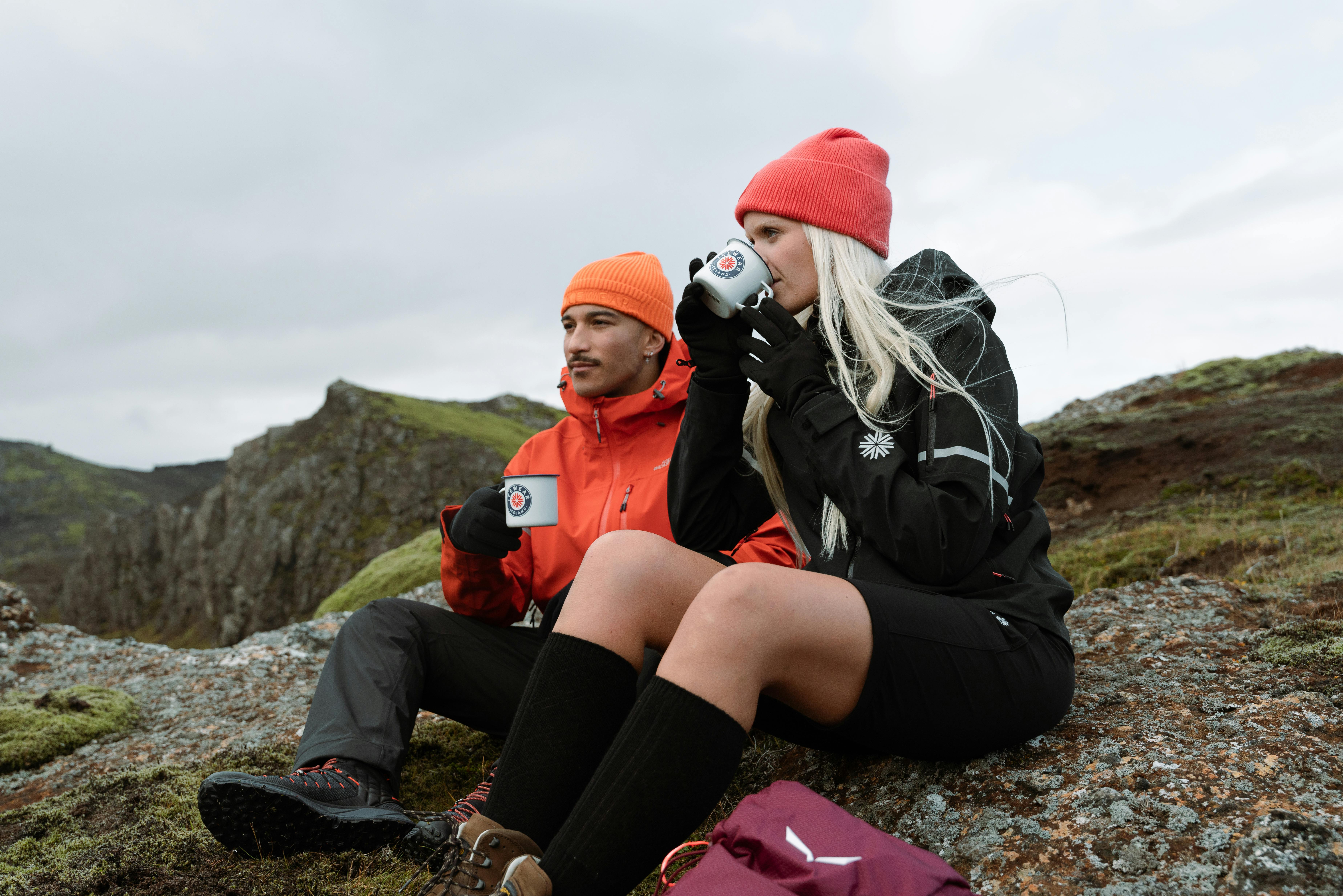 A couple resting and having coffee on their mountaineering trip