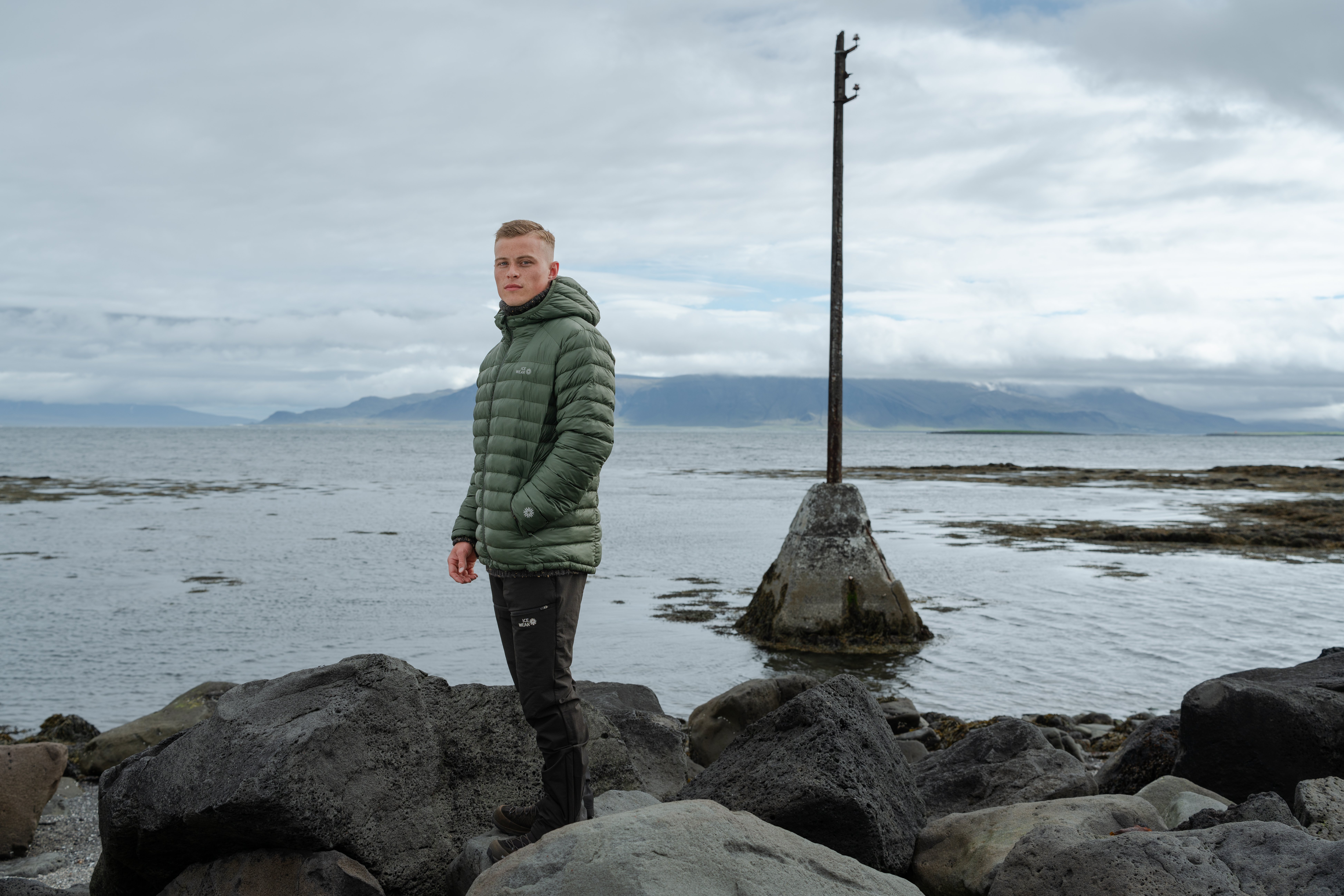 Men standing at Icelandic seashore