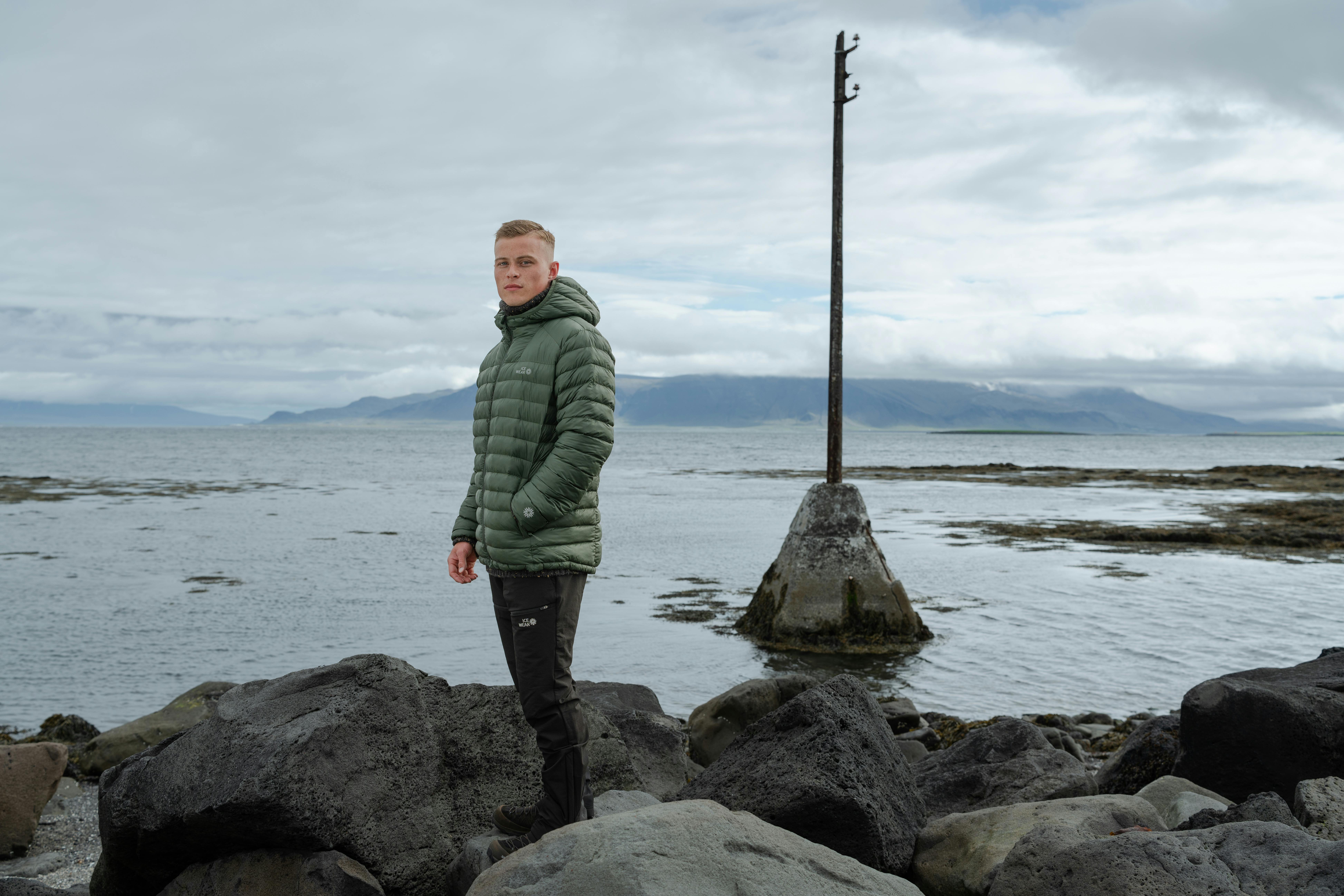 Men standing at Icelandic seashore