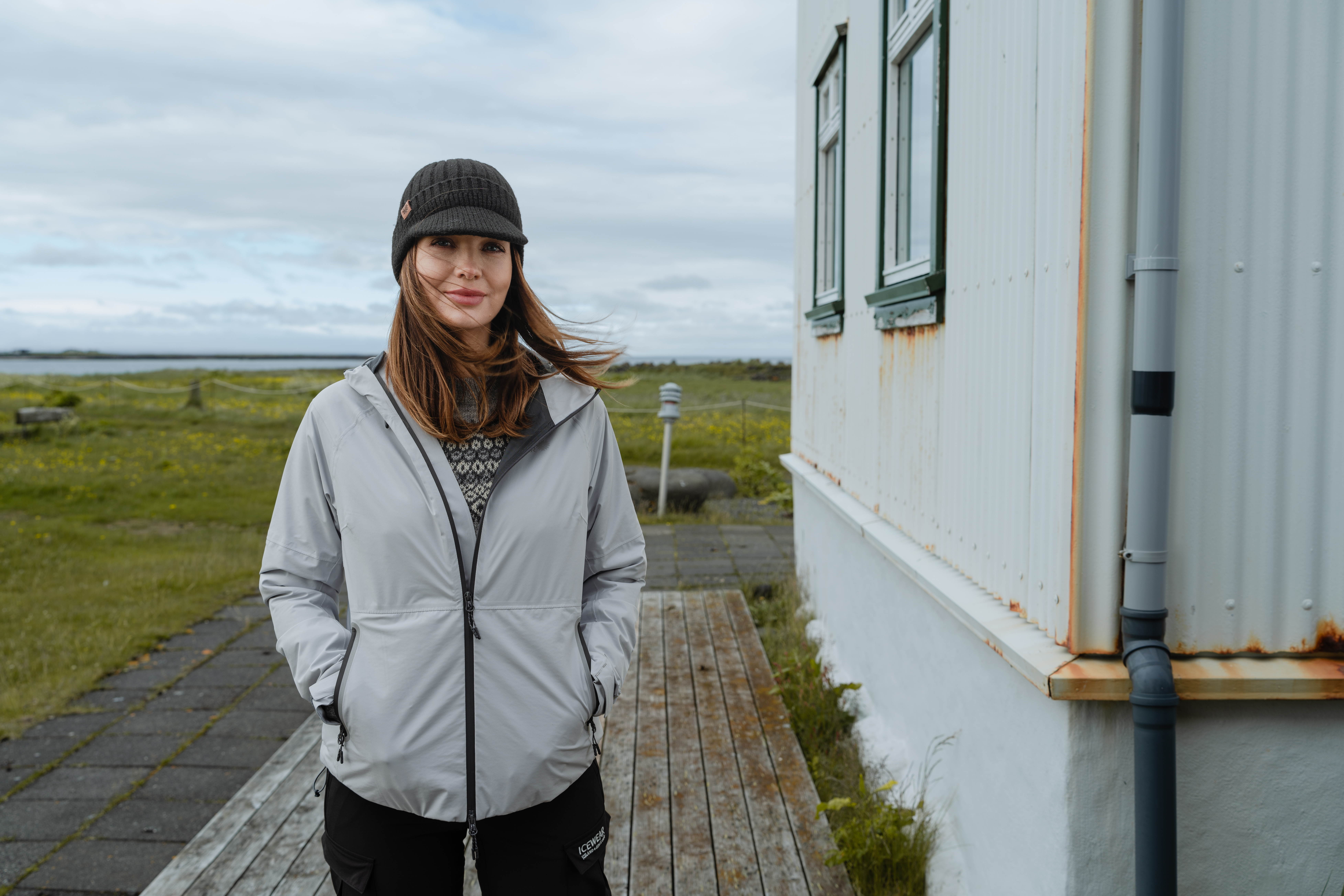 Woman standing at Icelandic house