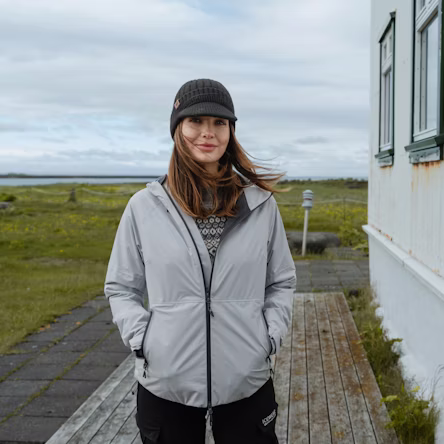 Woman standing at Icelandic house