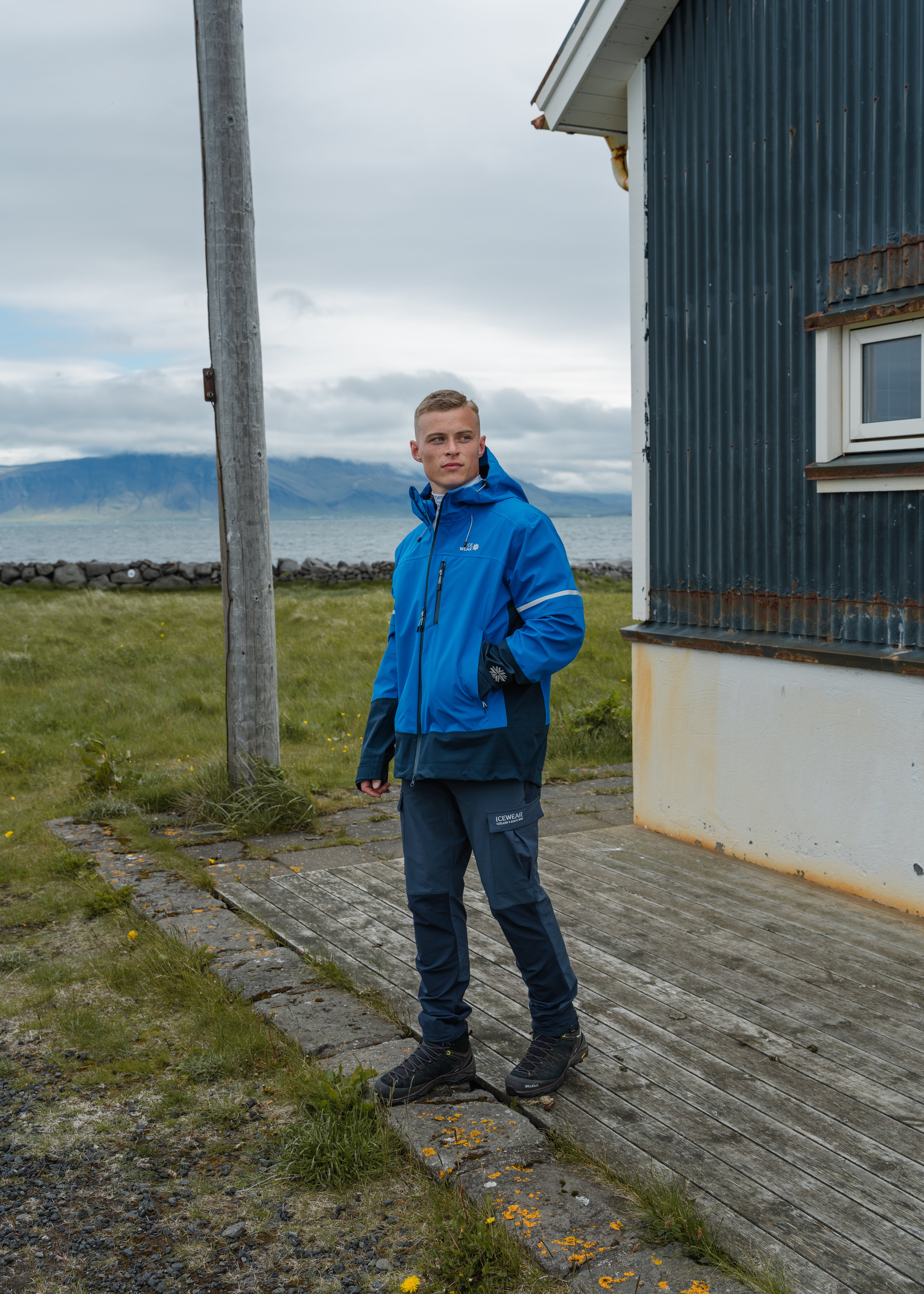 man standing by a house