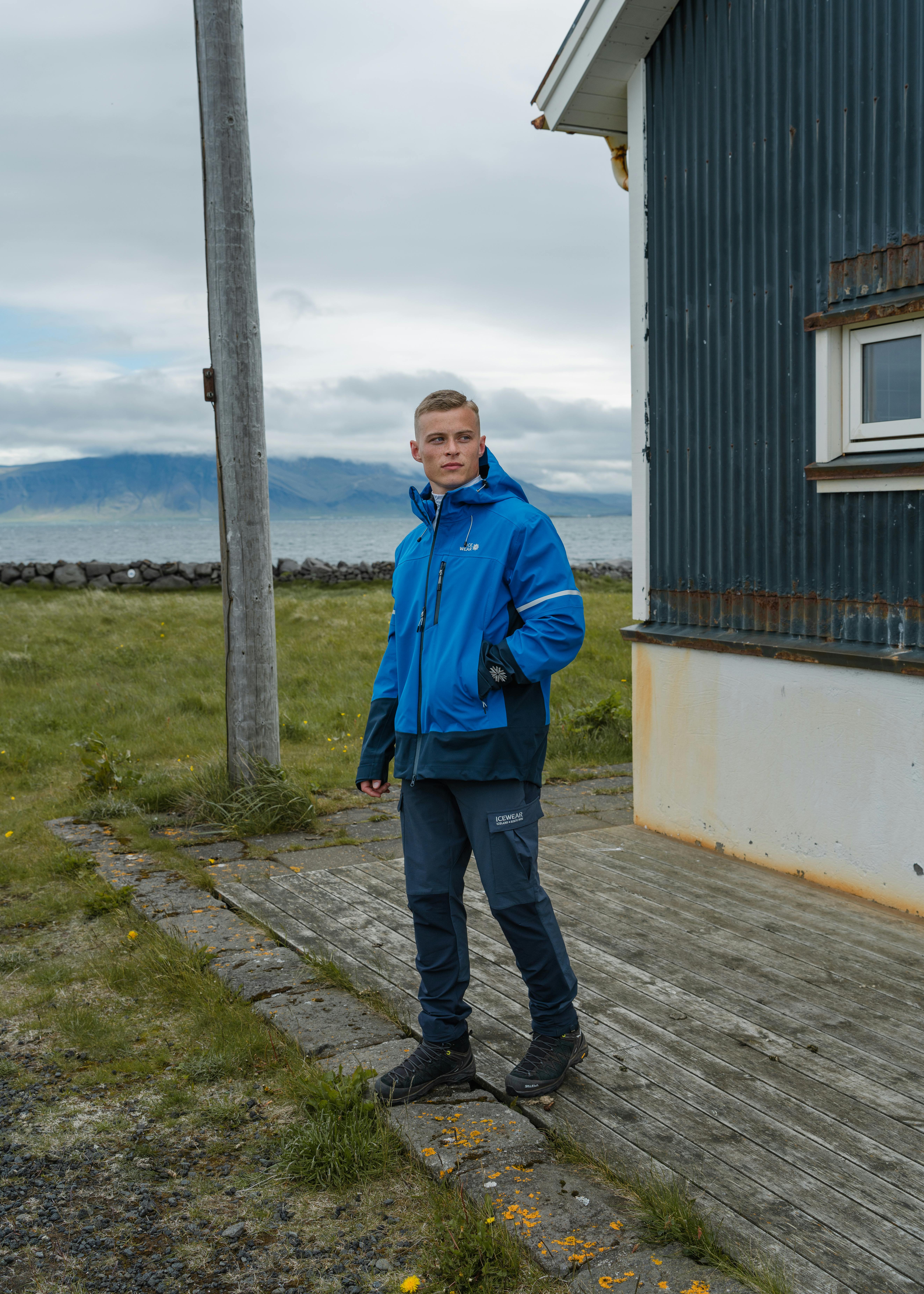man standing by a house