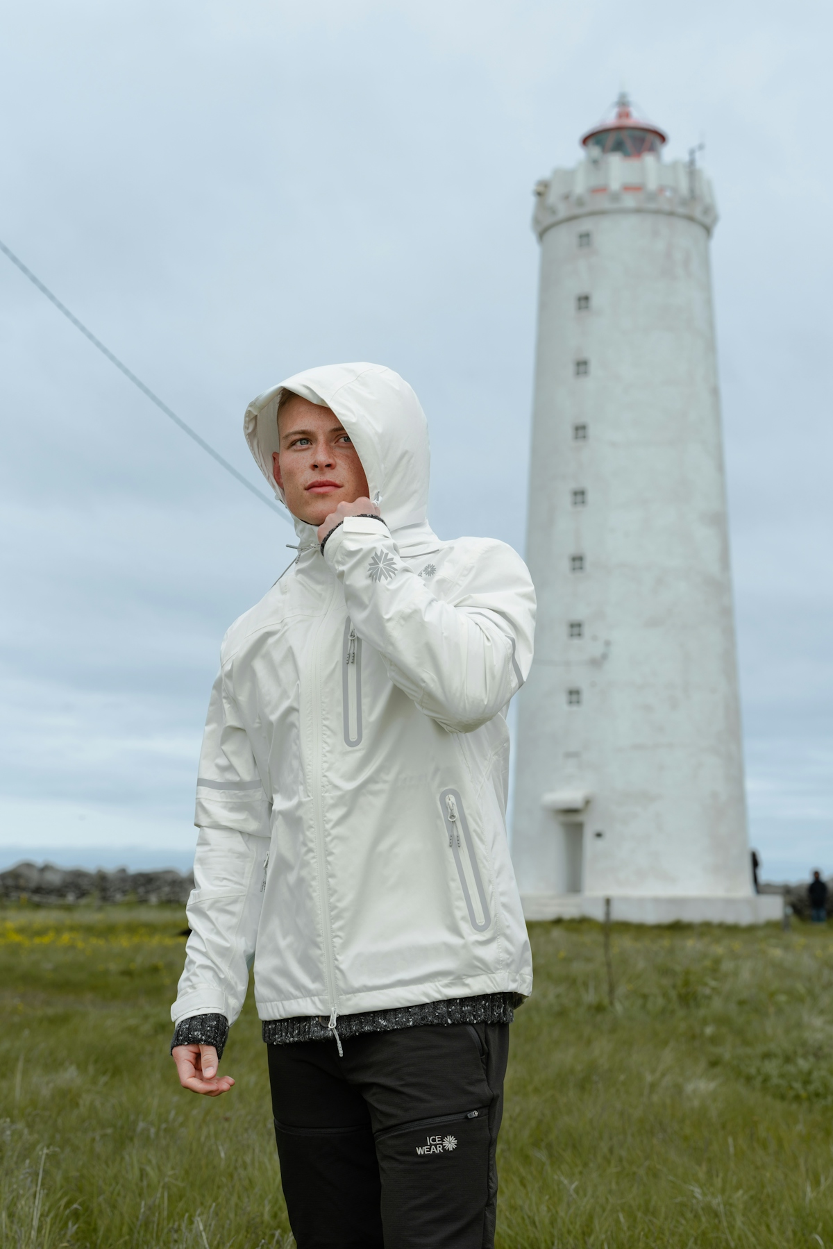 man-white-jacket-pants-lighthouse-1.jpeg