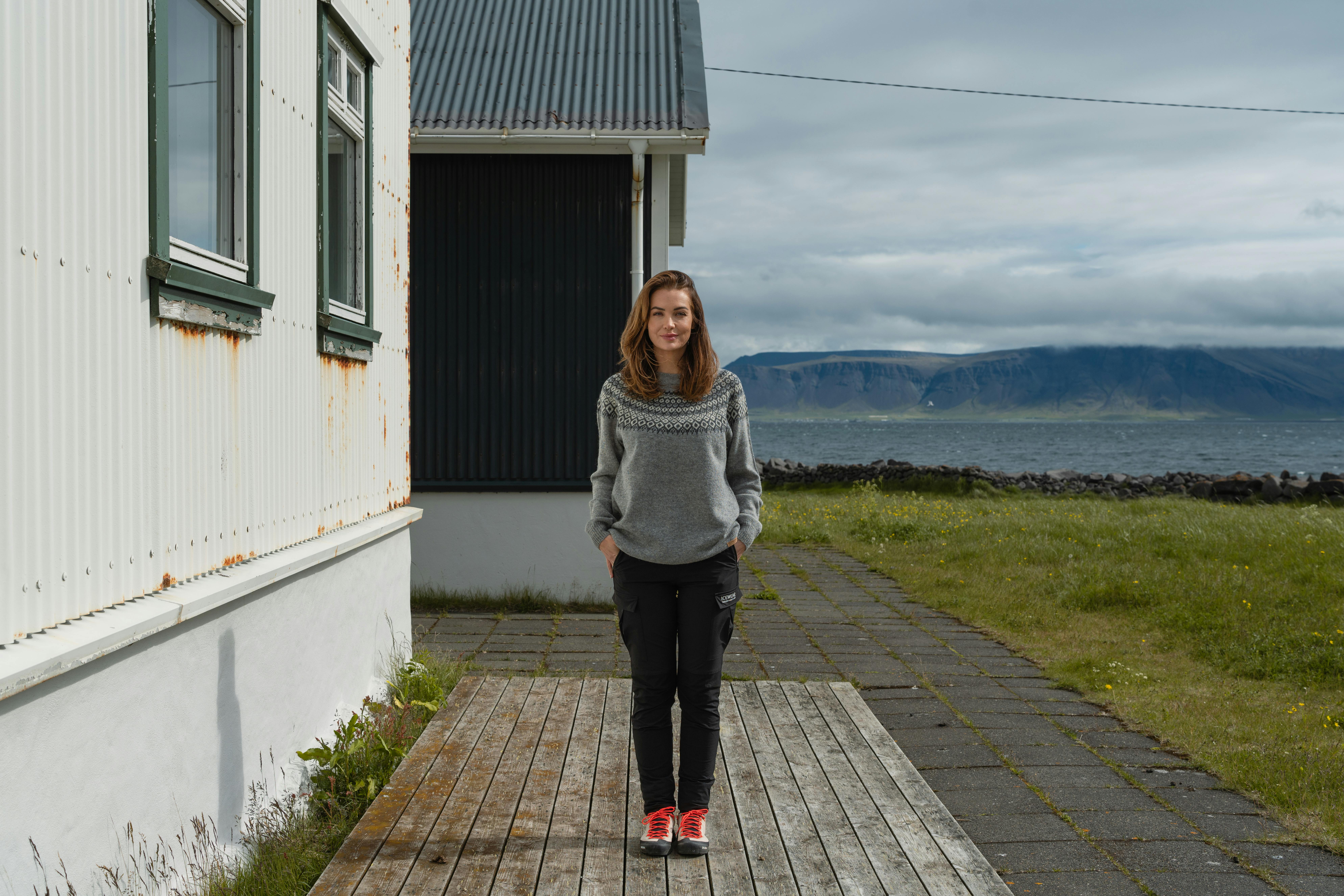 woman next to old house