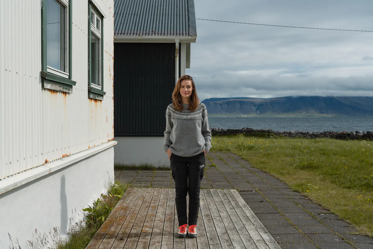 woman next to old house