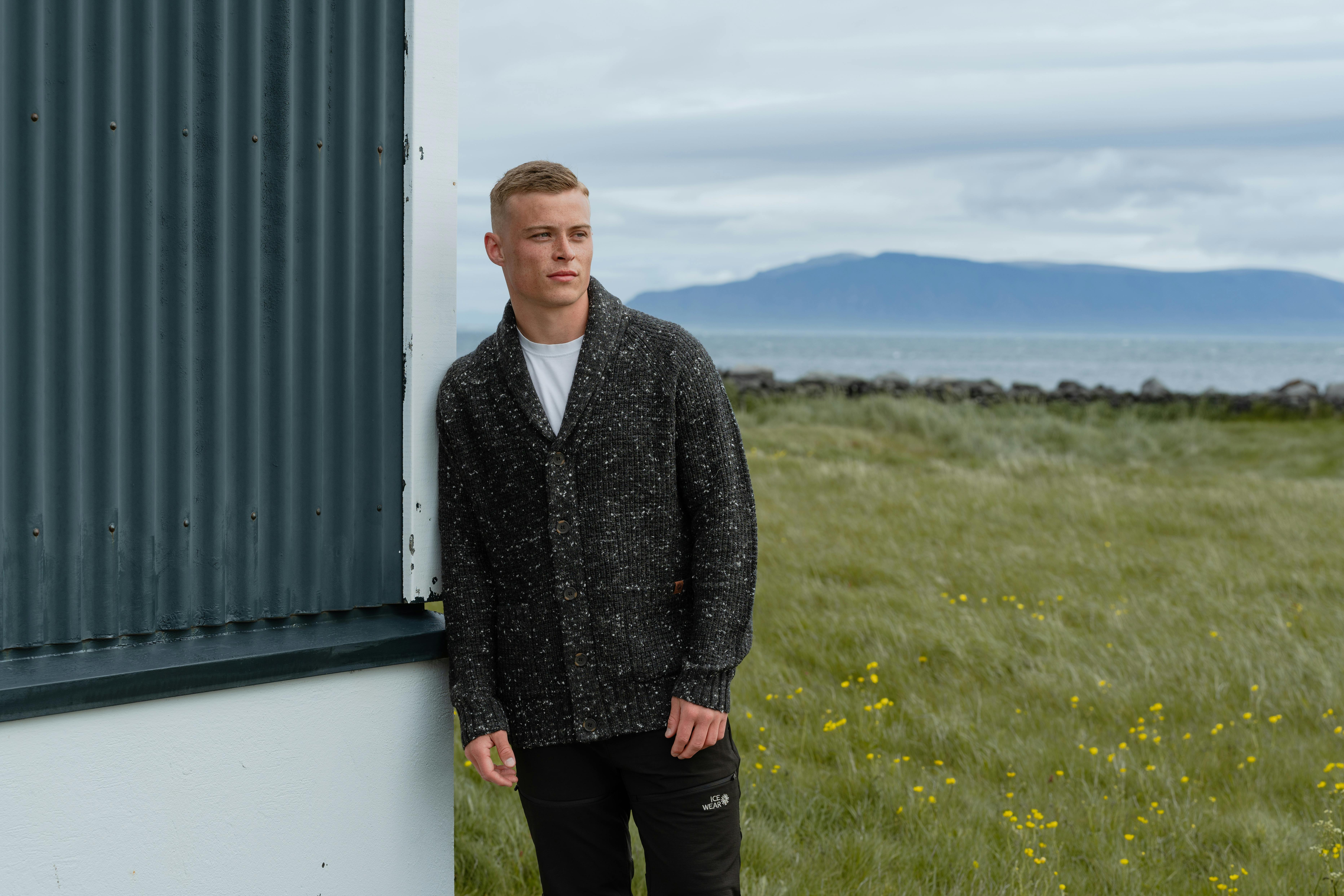 man standing by a house