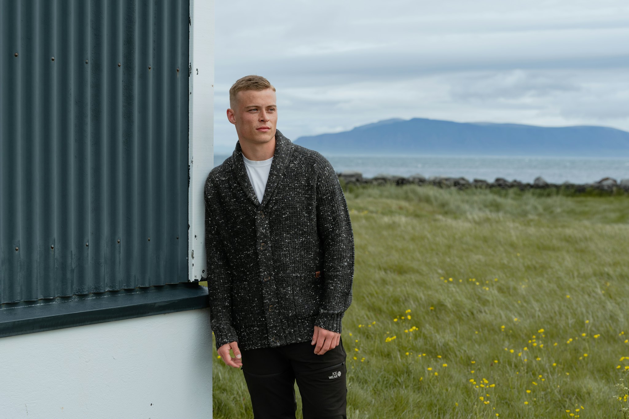 man standing by a house