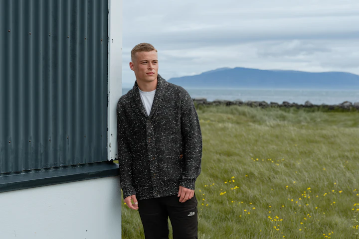 man standing by a house