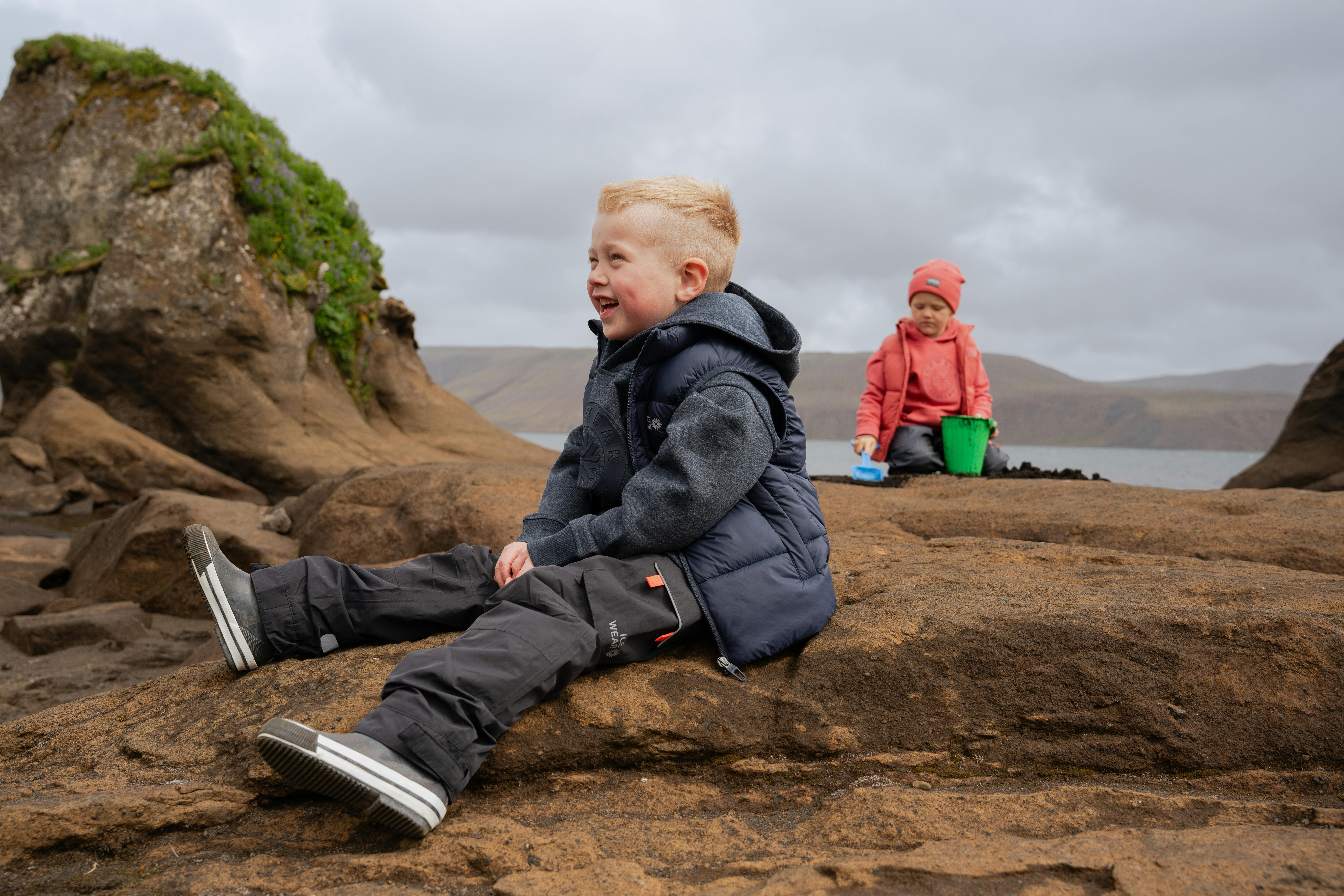 boys playing on cliff