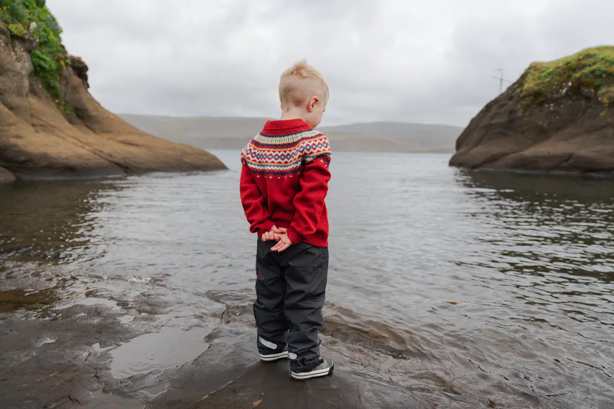 boy standing next to a lake in Iceland