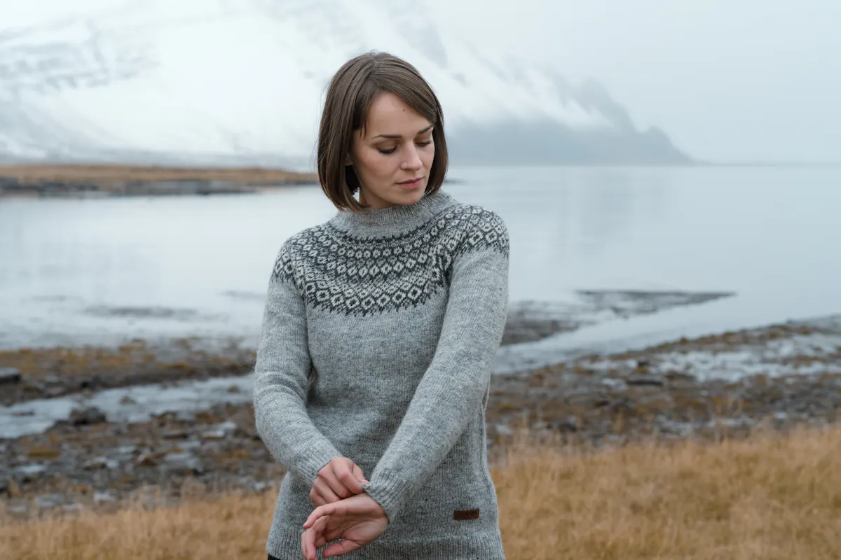 woman with sea and mountain behind her