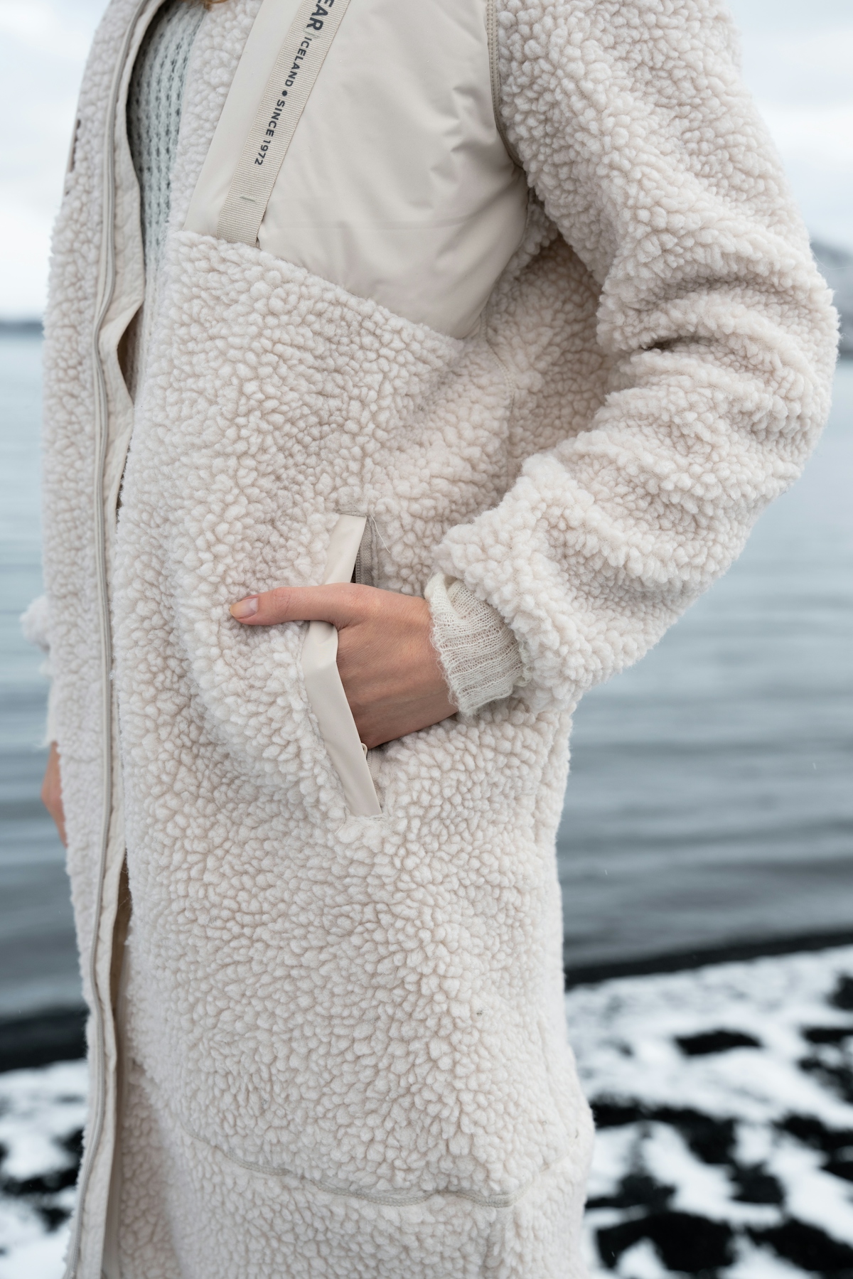 iceland-woman-snow-lake-white-sherpa-coat-7.jpeg