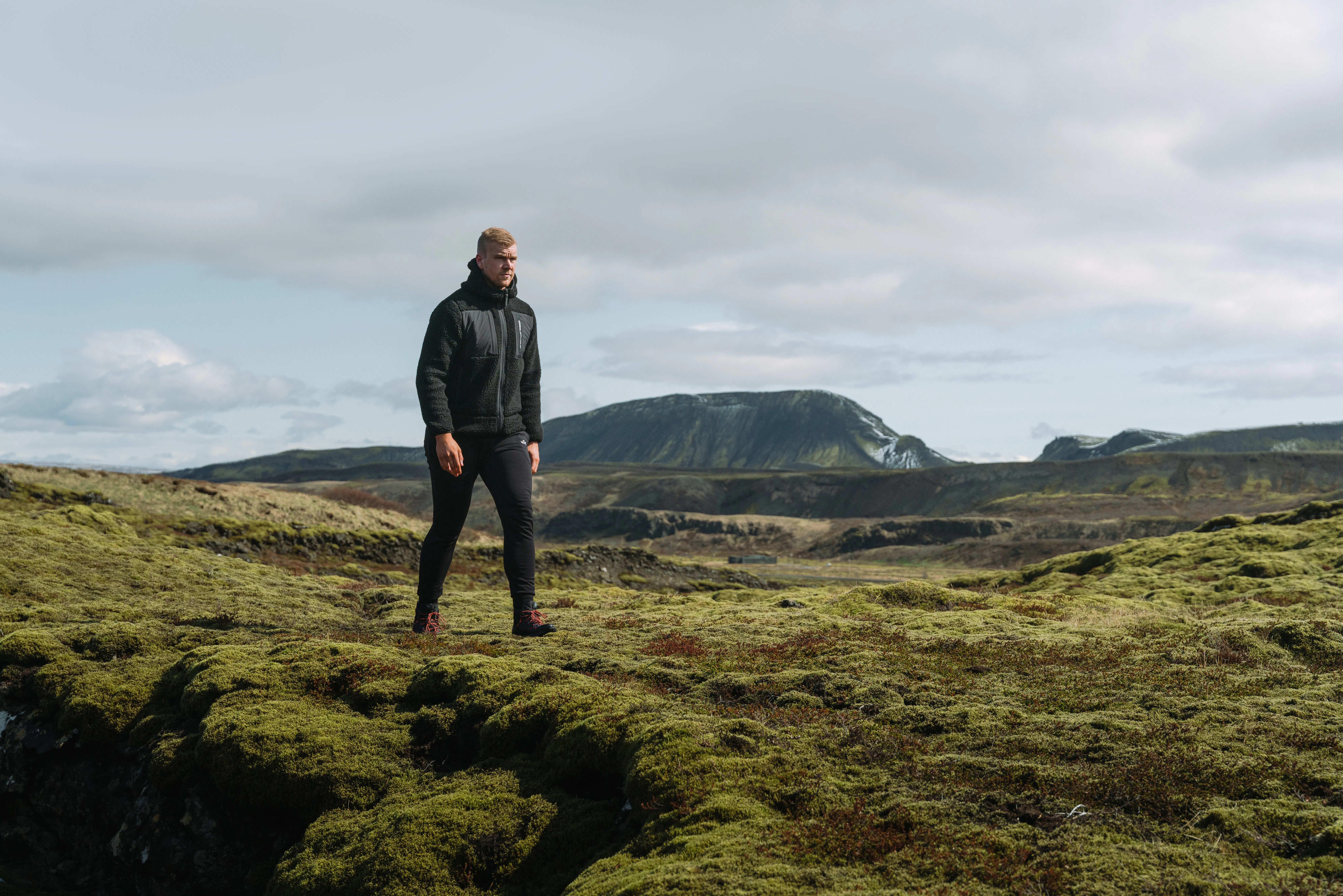 man walking in moss nature in Iceland