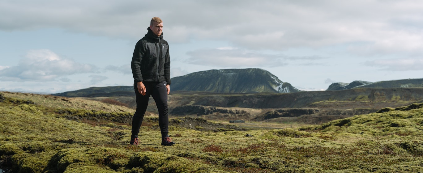man walking in moss nature in Iceland
