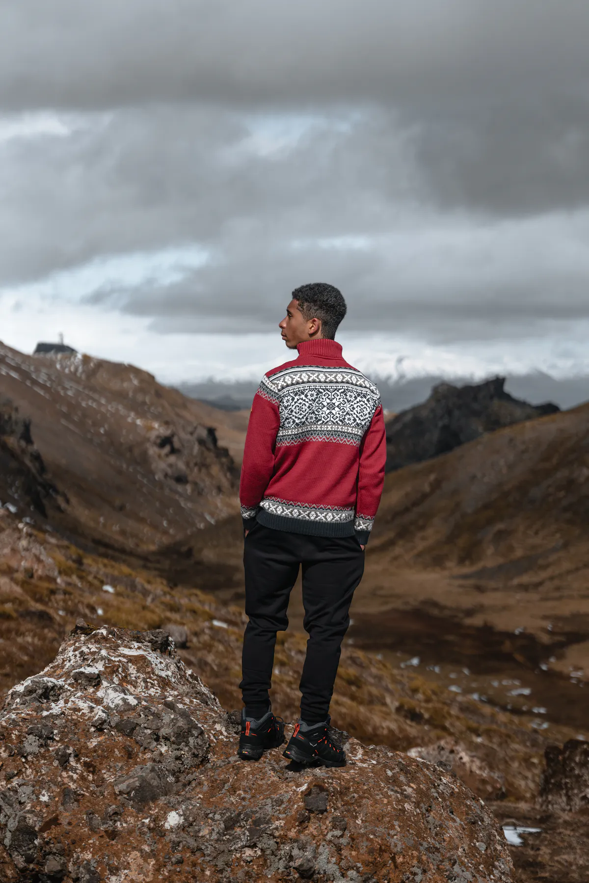 man wearing Norwegian sweater called Oslo up in the mountains