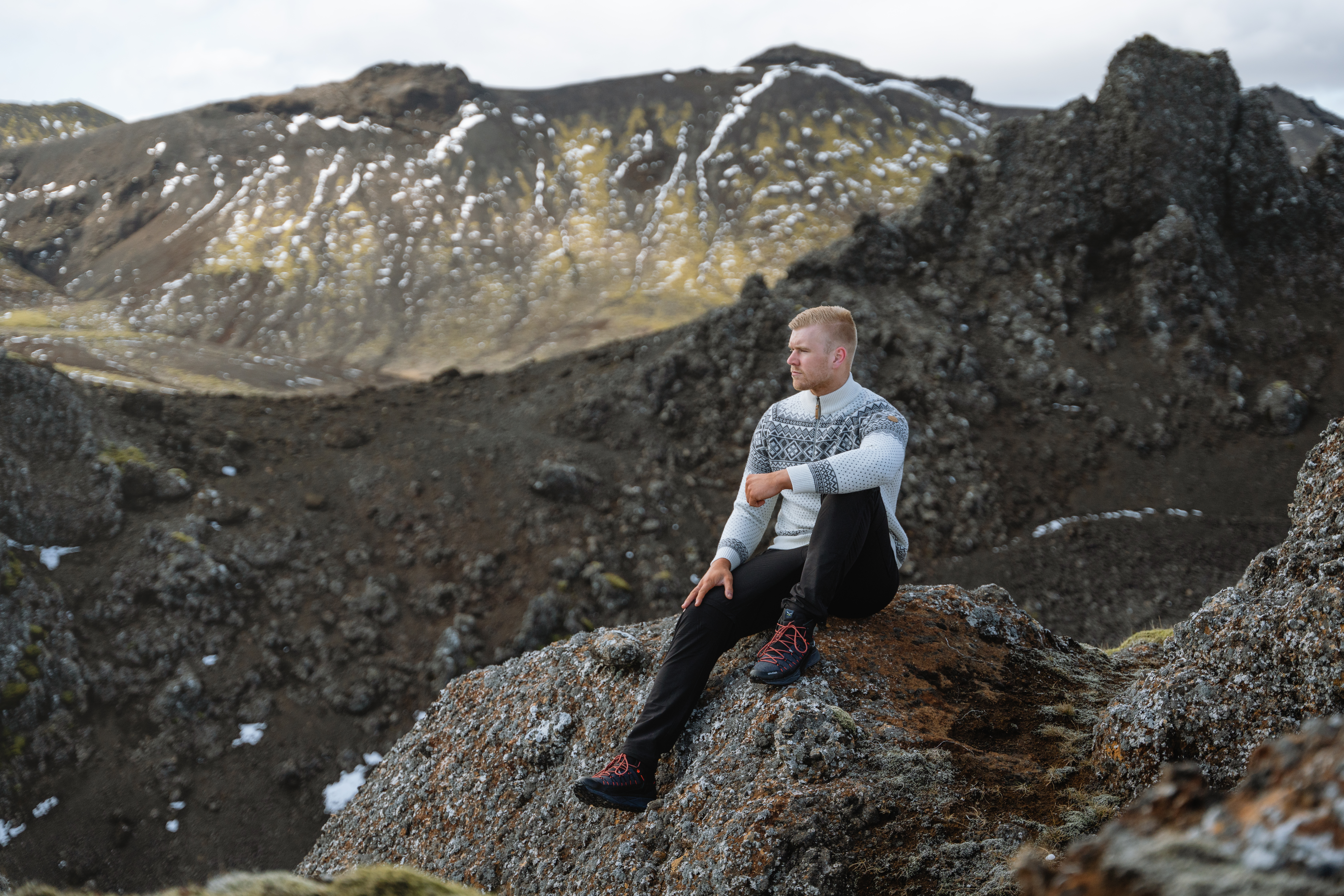 Man sitting on cliff in the mountain