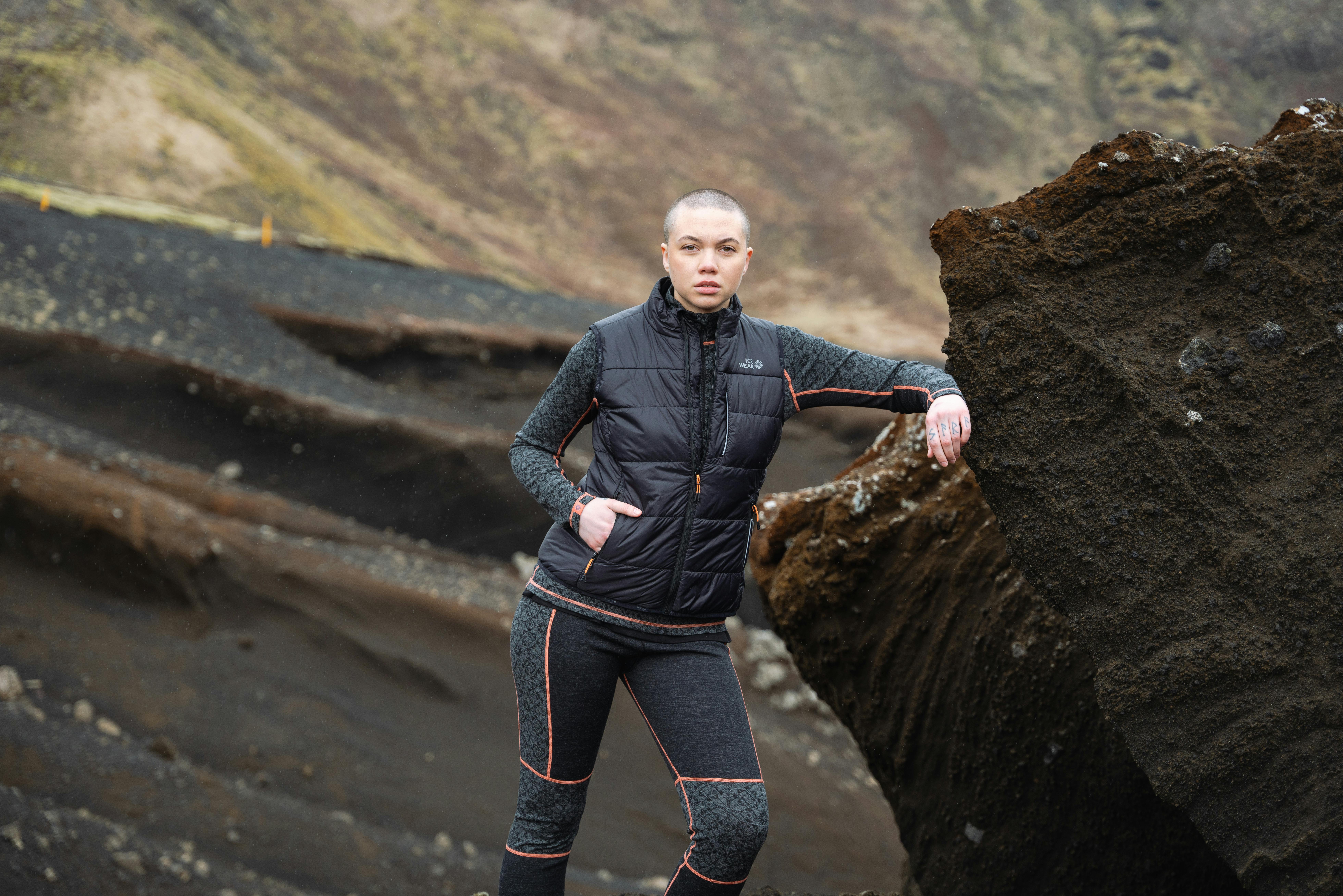 woman next to big rock