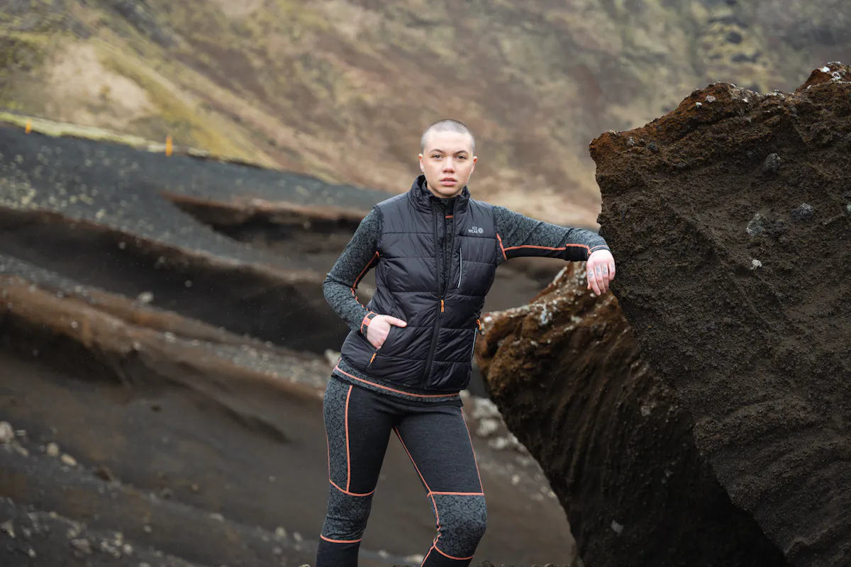 woman next to big rock
