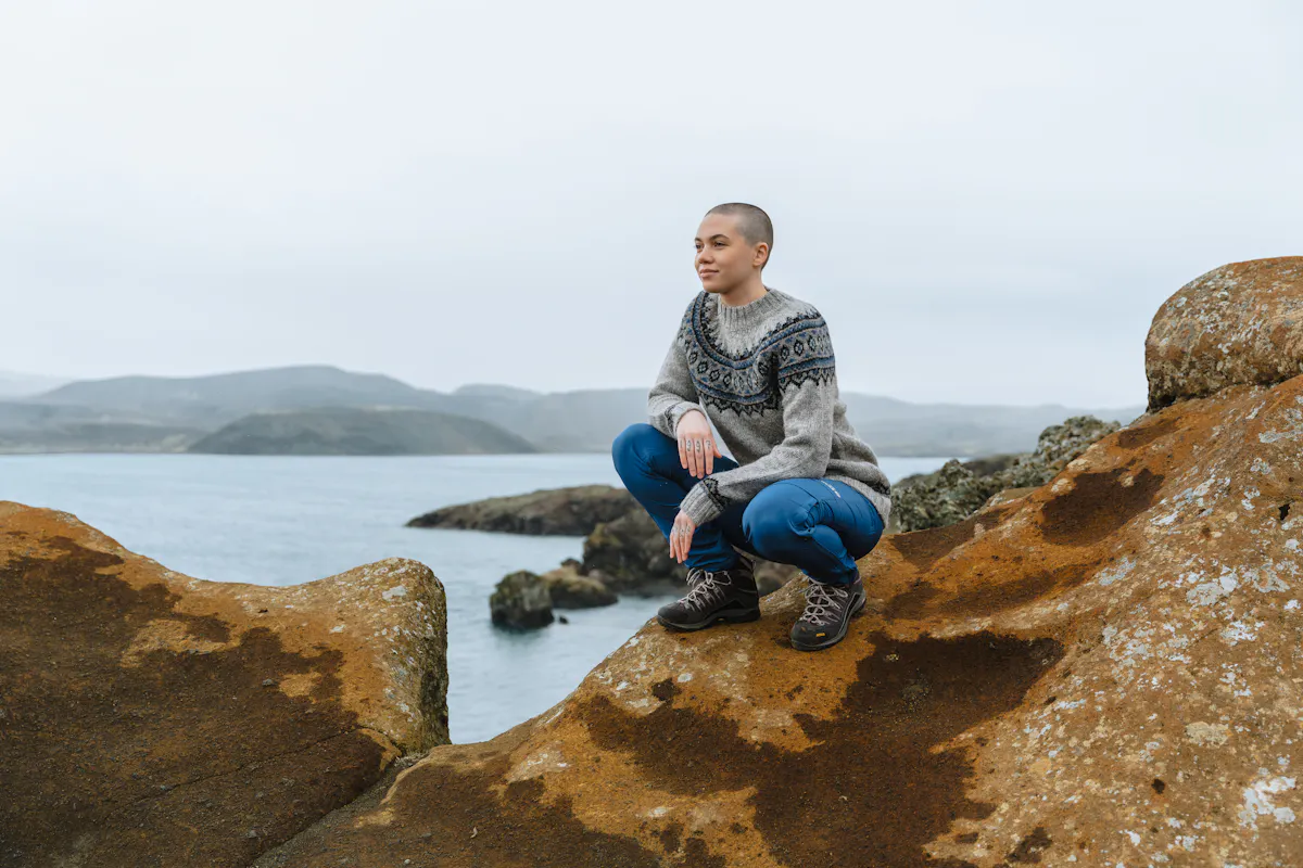 woman on a cliff next to the sea