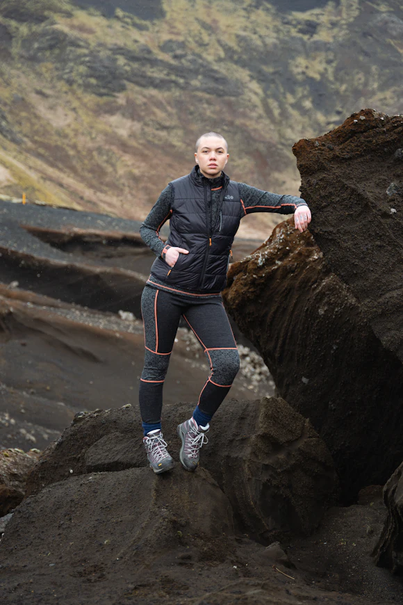 woman leaning on Icelandic black rock