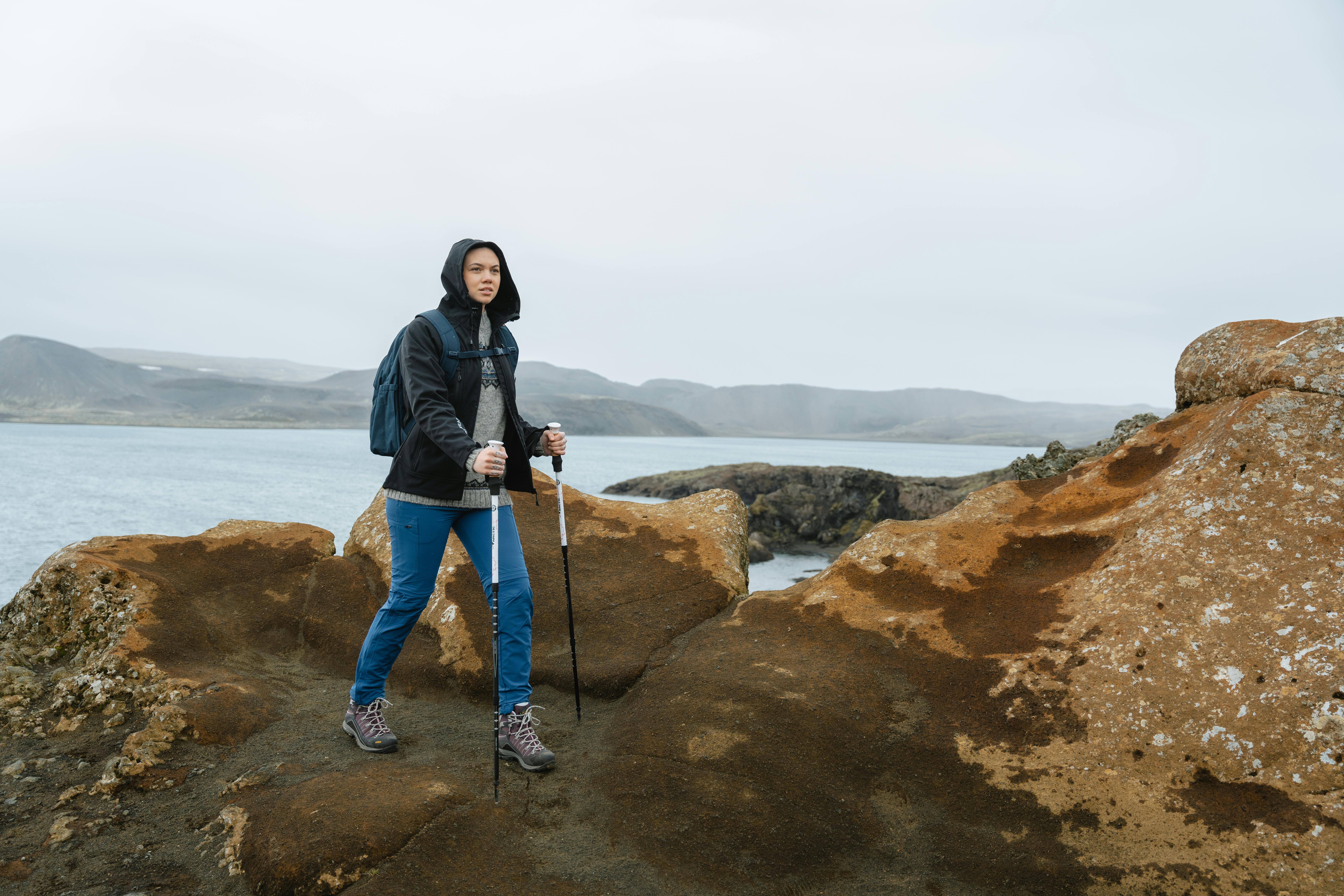 woman hiking, the sea and mountain behind her