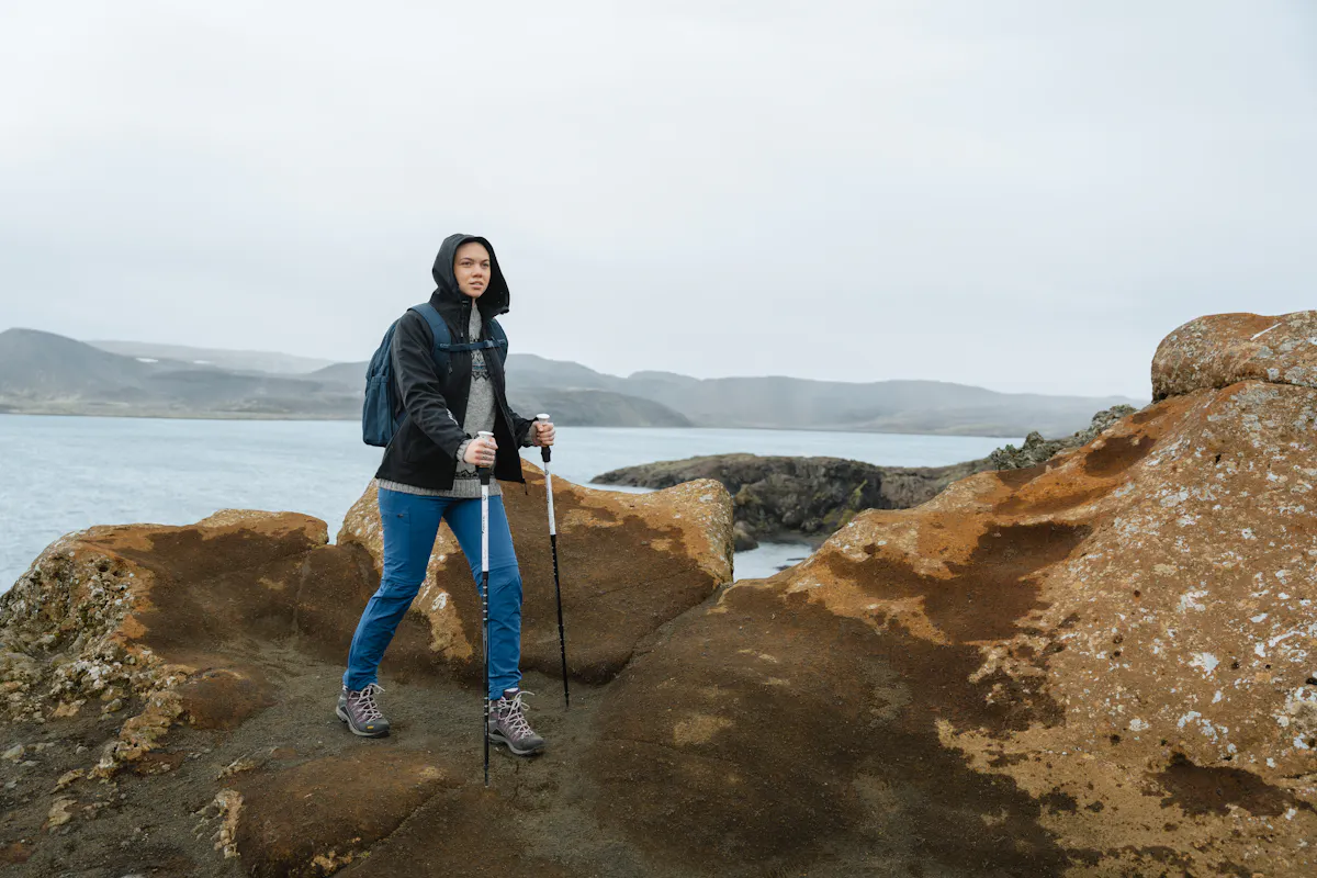 woman hiking, the sea and mountain behind her
