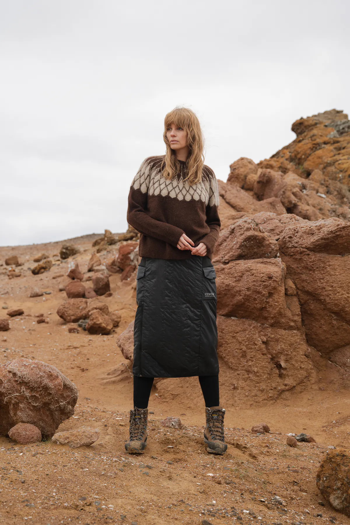 woman standing next to rocks