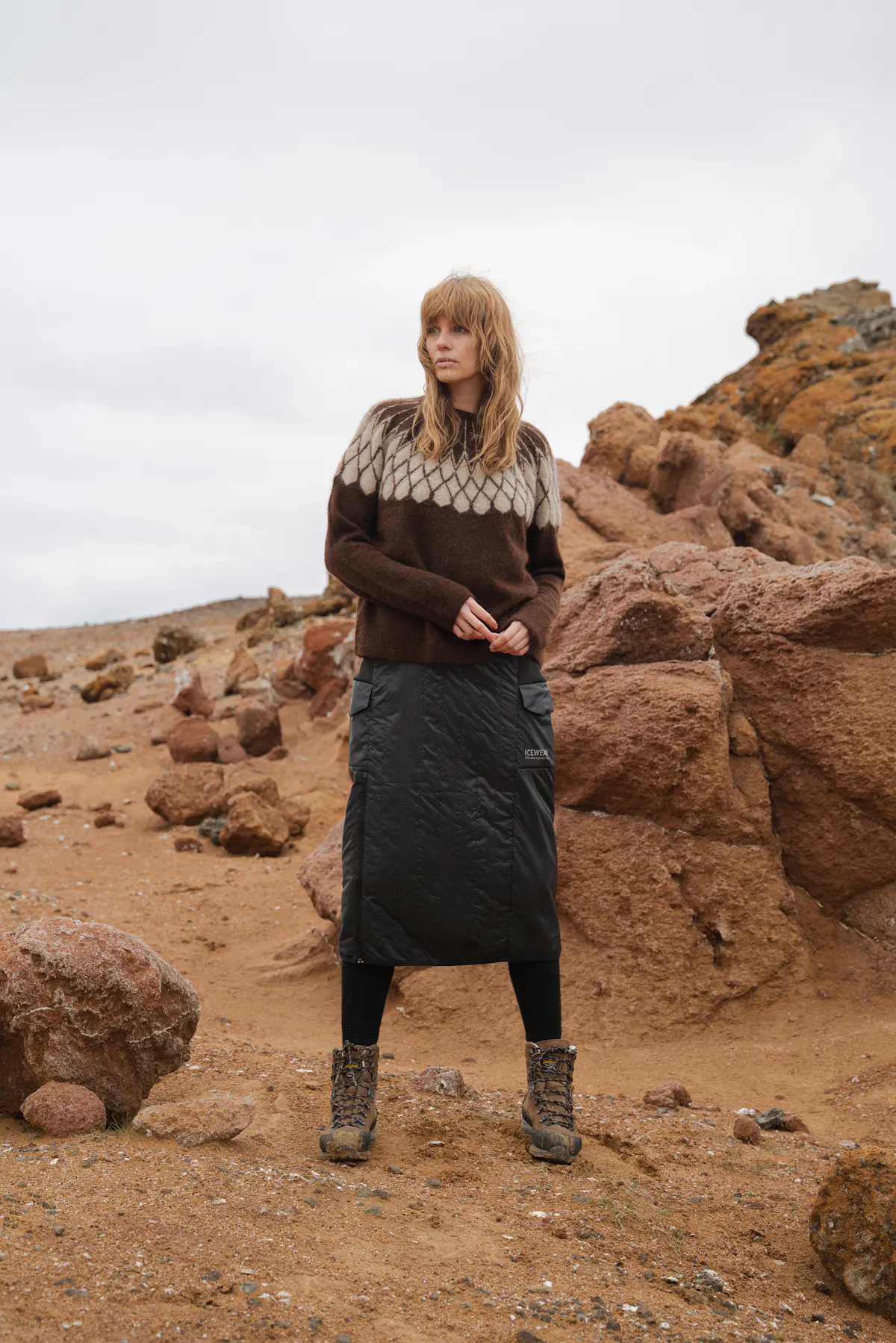 woman standing next to rocks