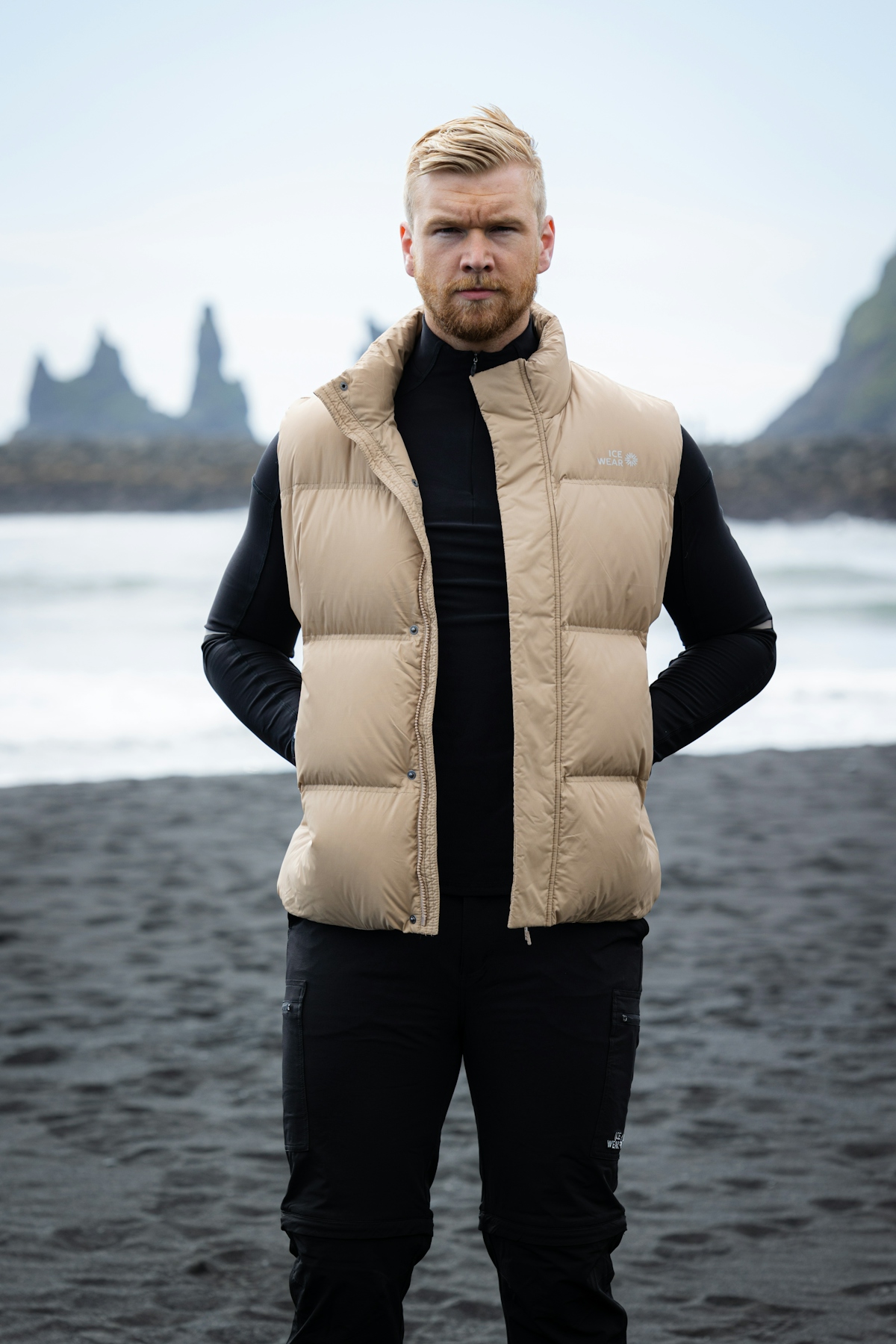 man-lightbrown-vest-blackbeach.jpeg