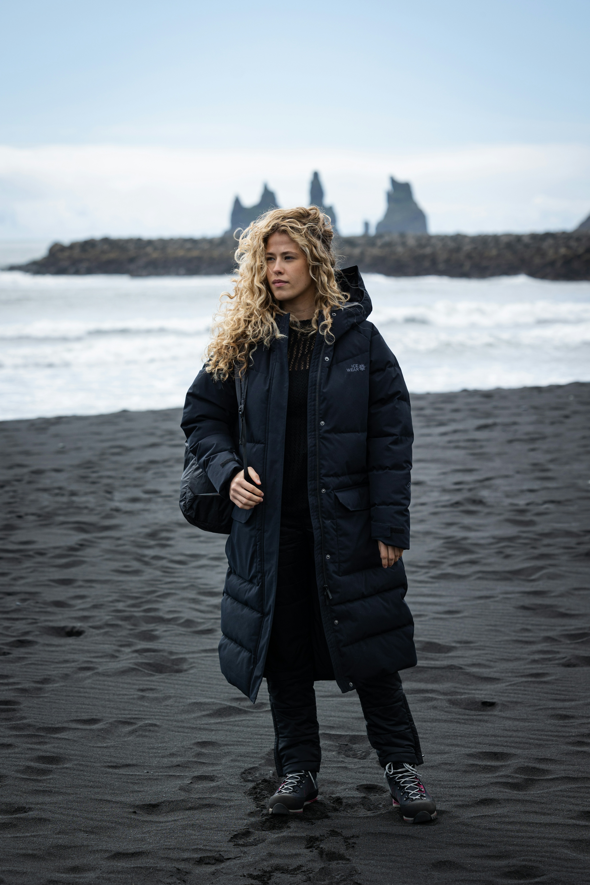 woman-long-black-jacket-beach.jpeg