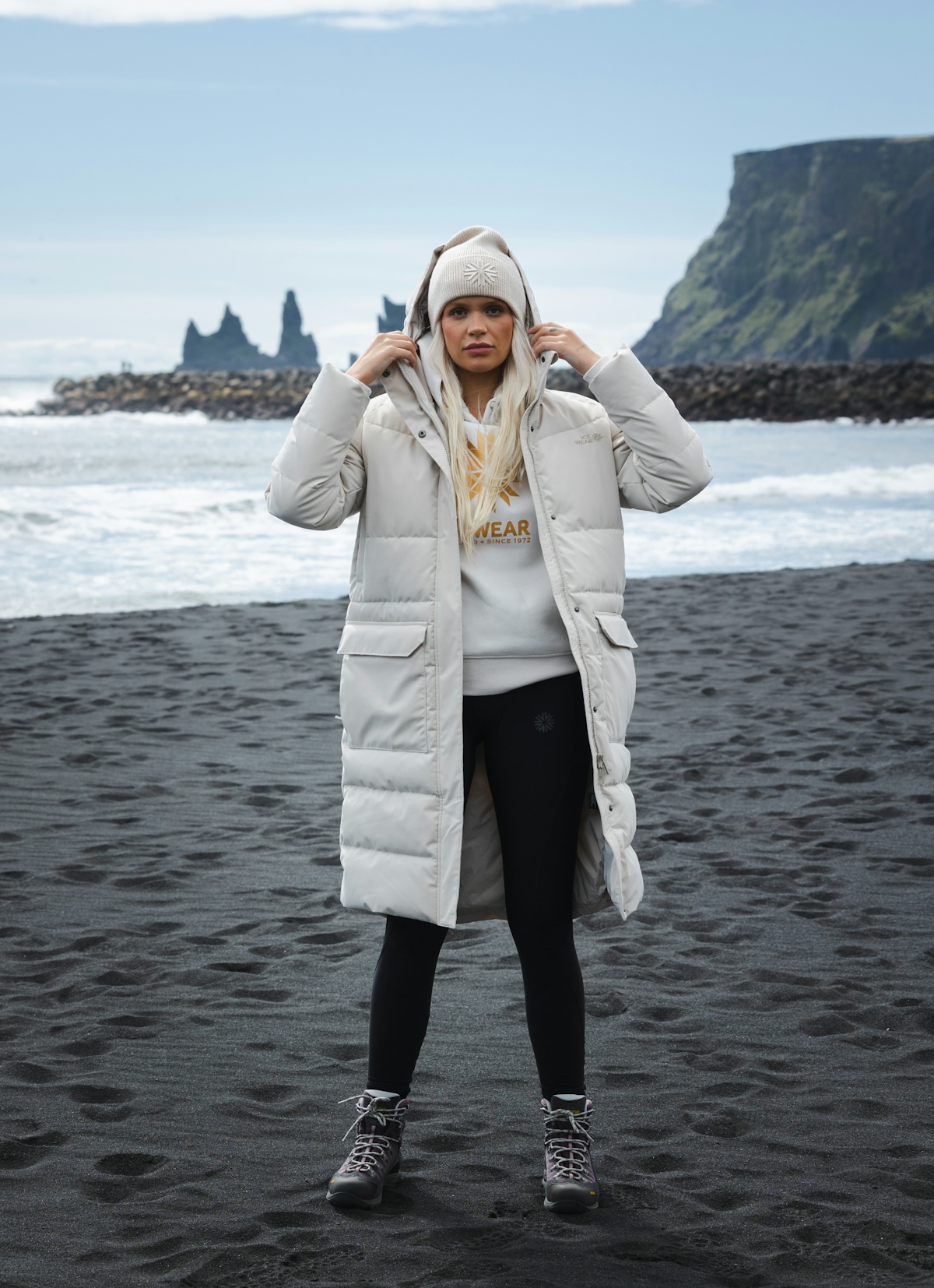 woman-white-long-jacket-blackbeach.jpeg